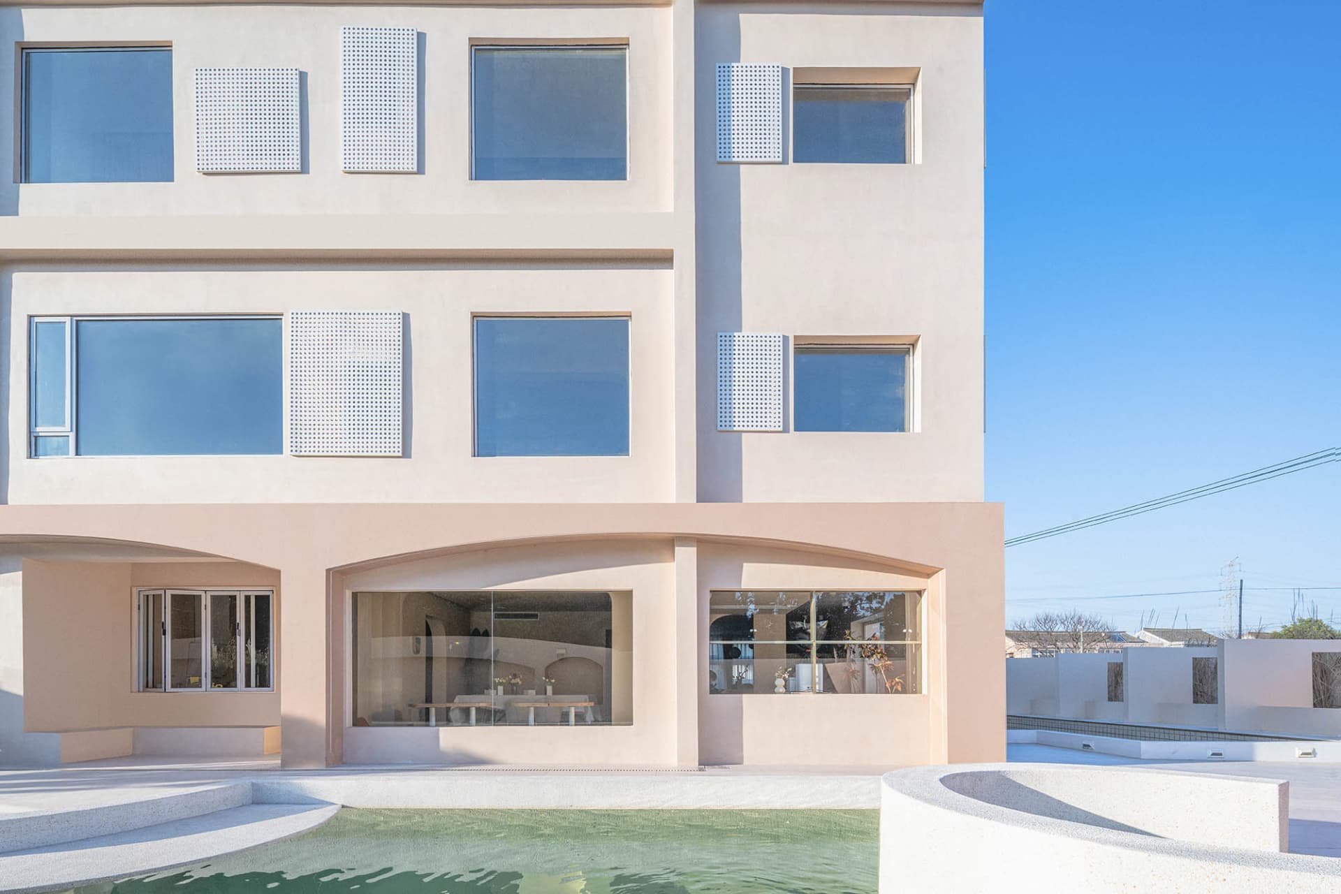 A modern building with concrete facade and large windows.