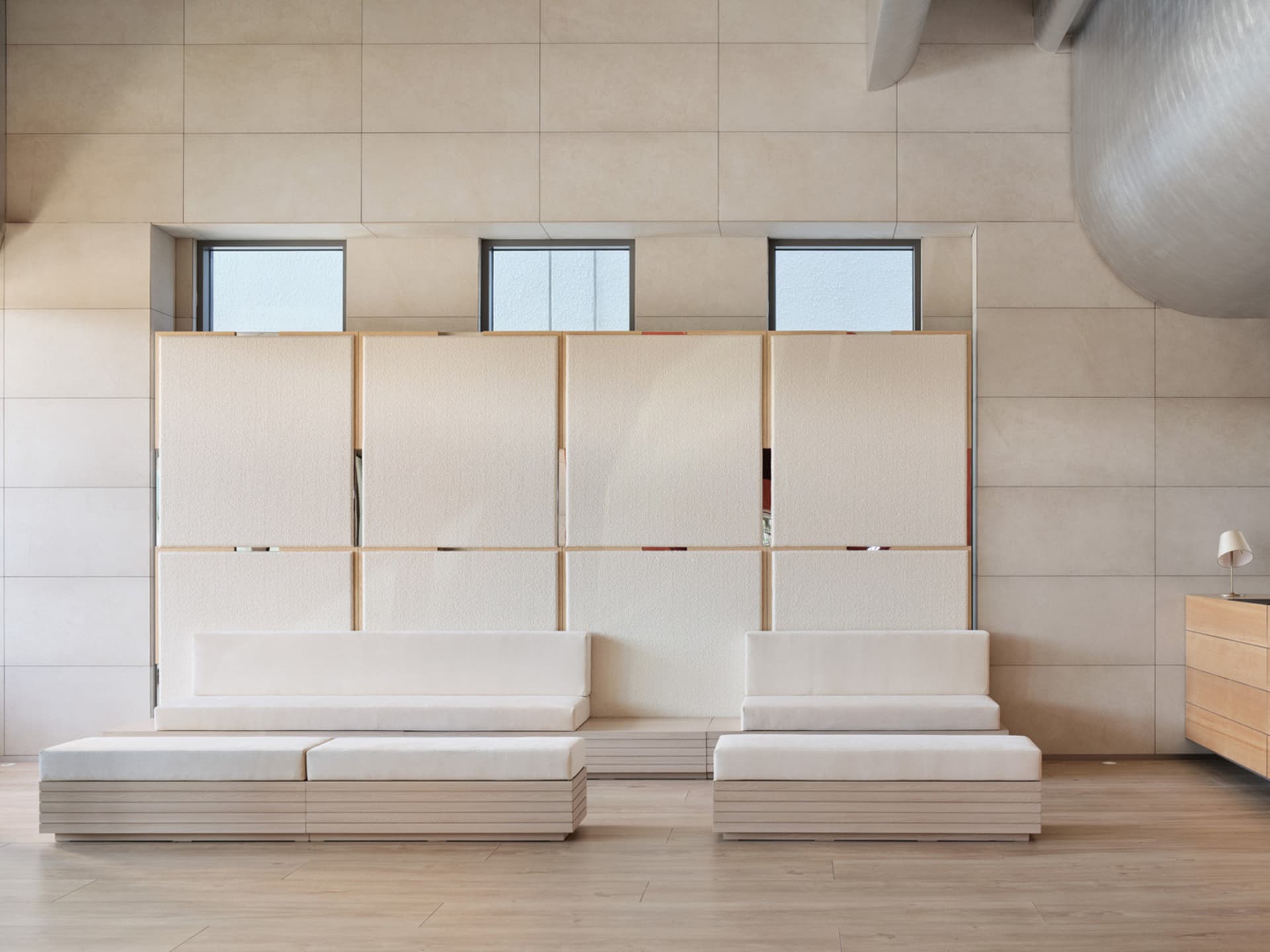 Minimalist living room with white sofas and wooden bench seating, glass windows, and a modern light fixture.