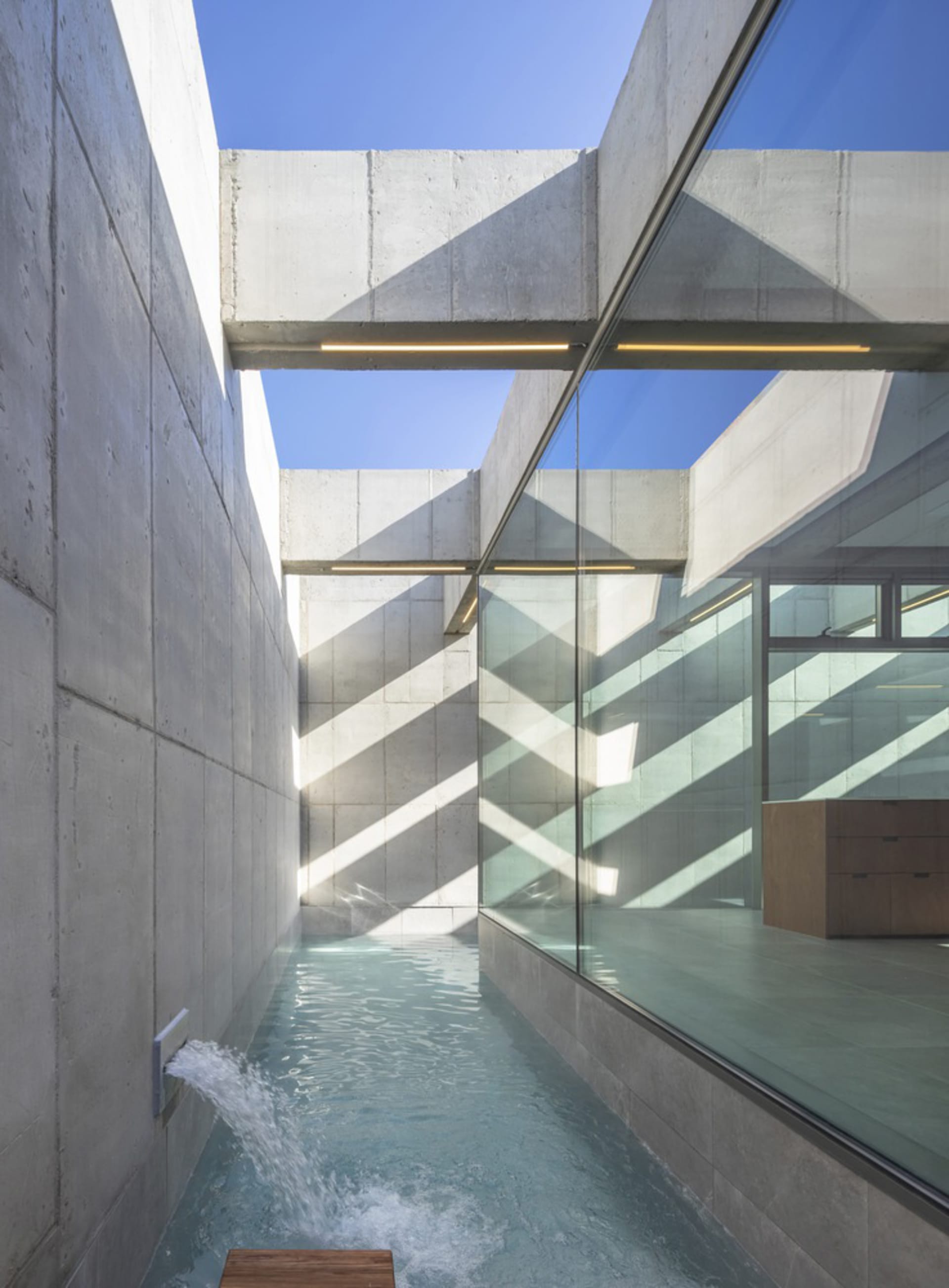 Modern interior design featuring concrete and glass materials