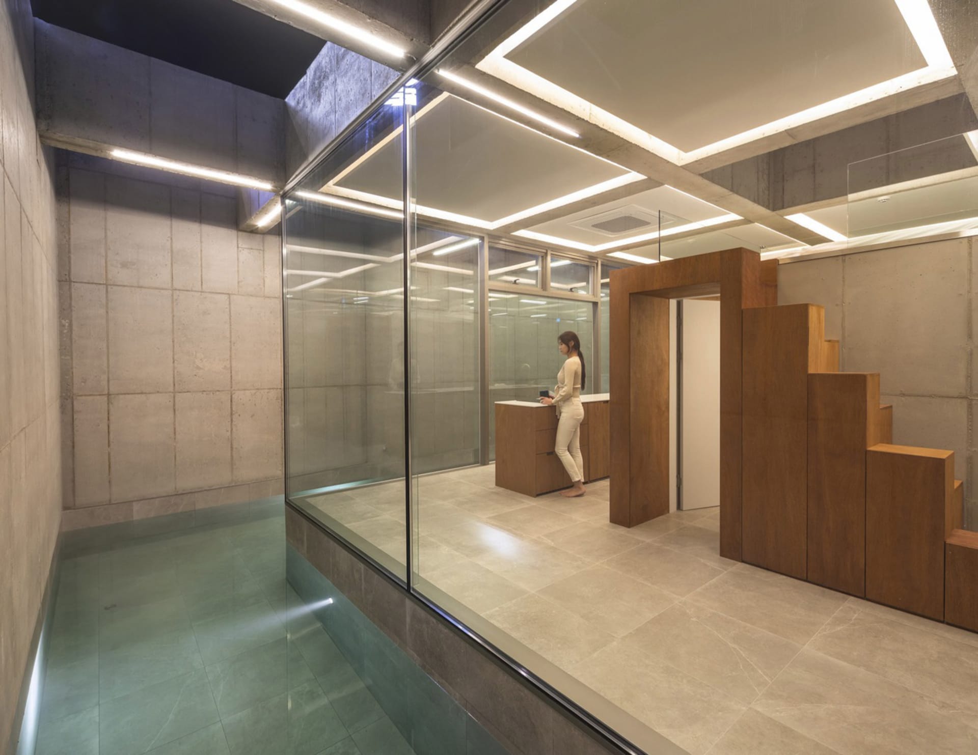 Industrial-style interior design featuring concrete walls and floor, with modern wooden accents.