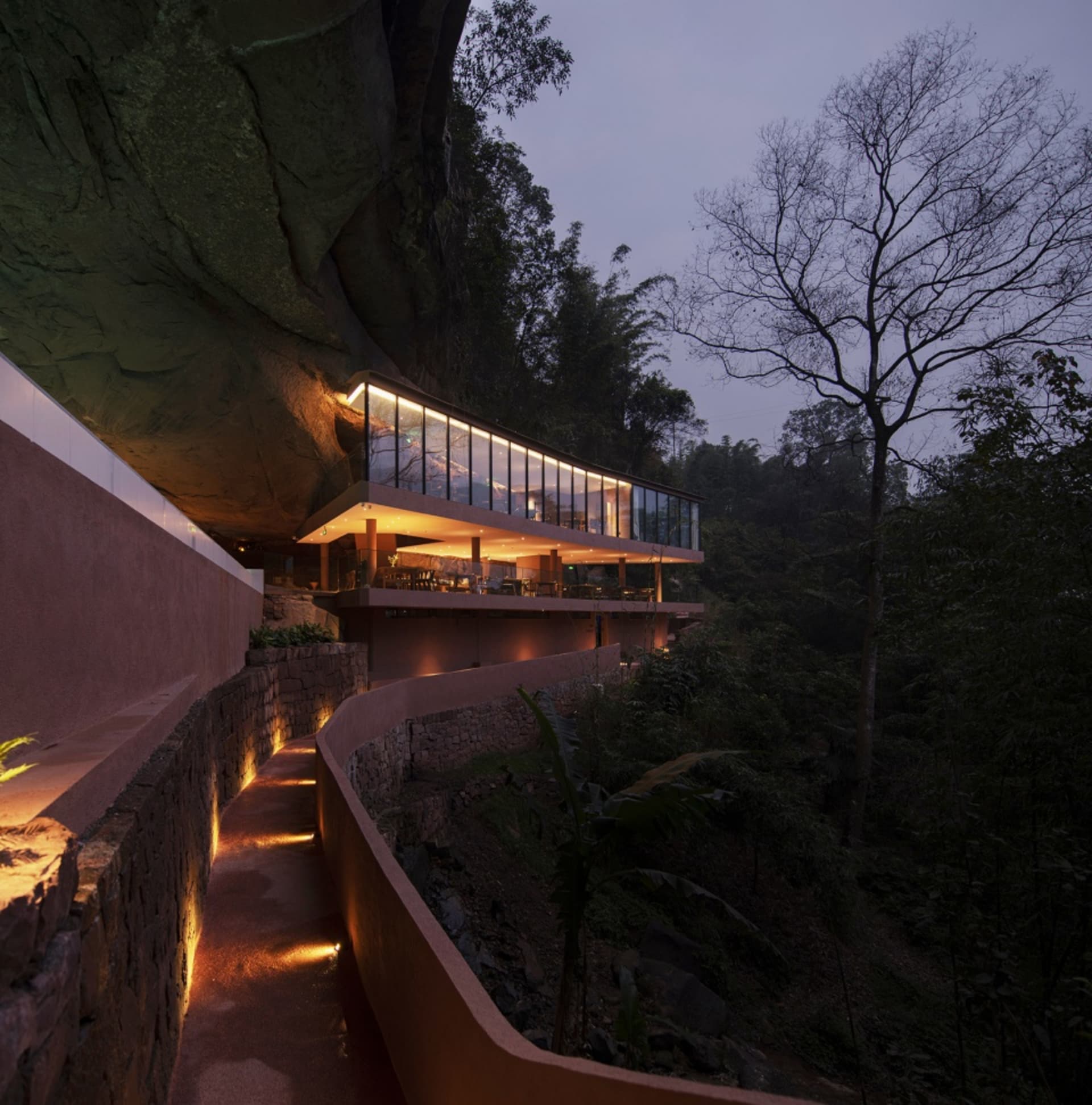 Modern residential building with concrete and glass structural elements.