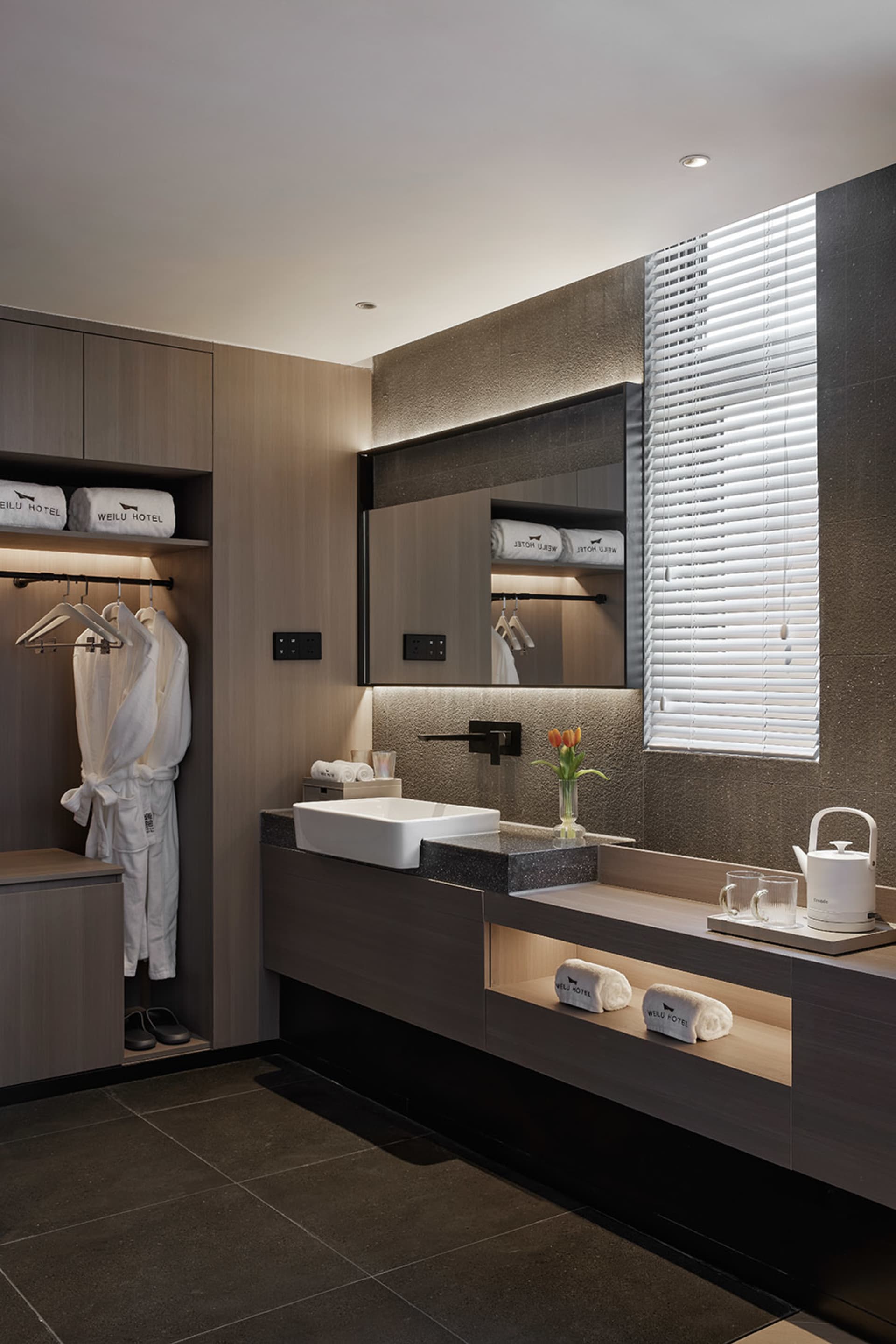 A modern residential bathroom featuring granite countertops and a clean, minimalist design.
