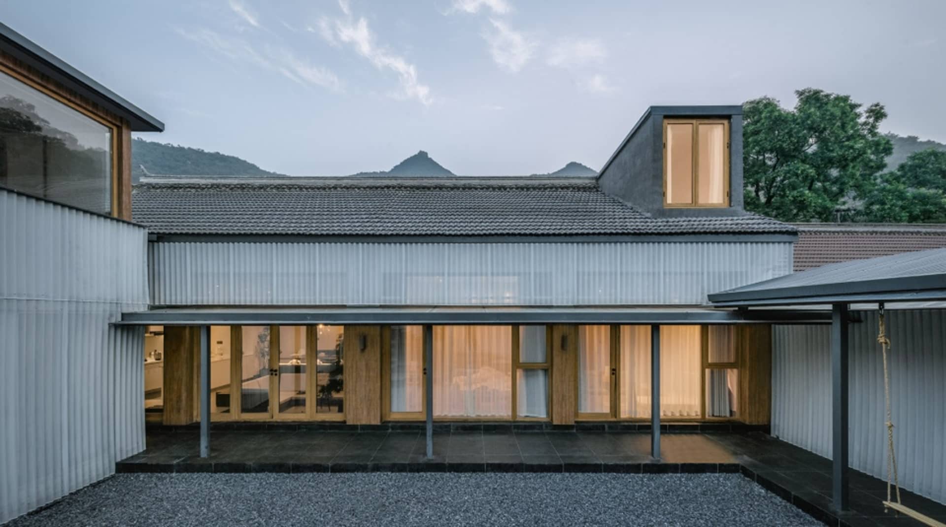 A modern residential building with wooden, metallic, and glass elements.
