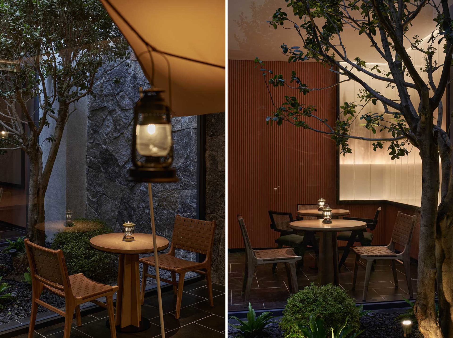 Industrially designed restaurant seating area with wooden tables and chairs, a lantern, and greenery.