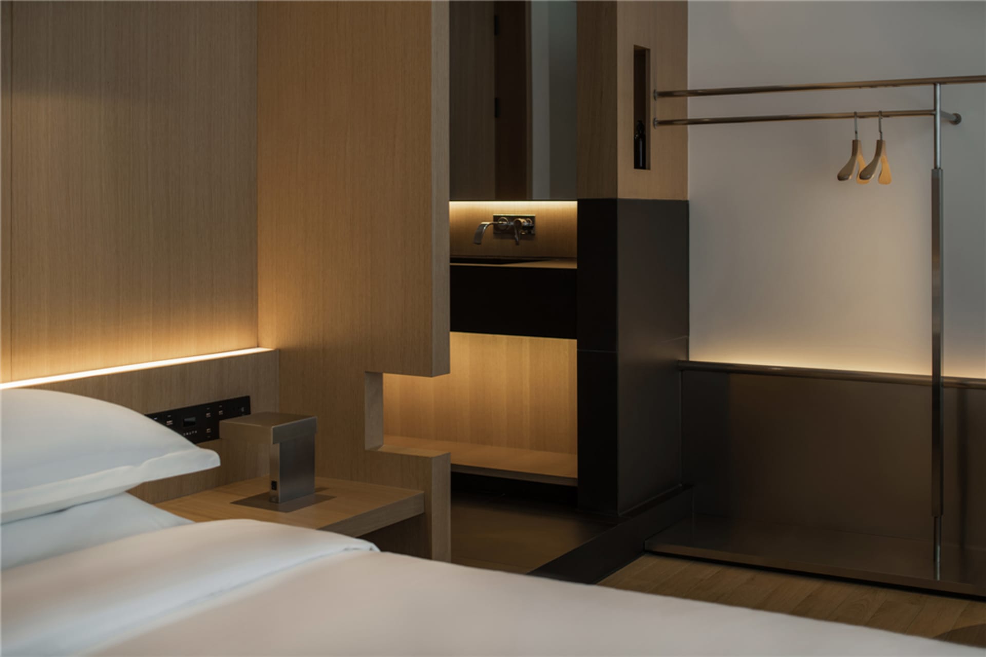 Modern bedroom with wooden walls and a minimalist design.