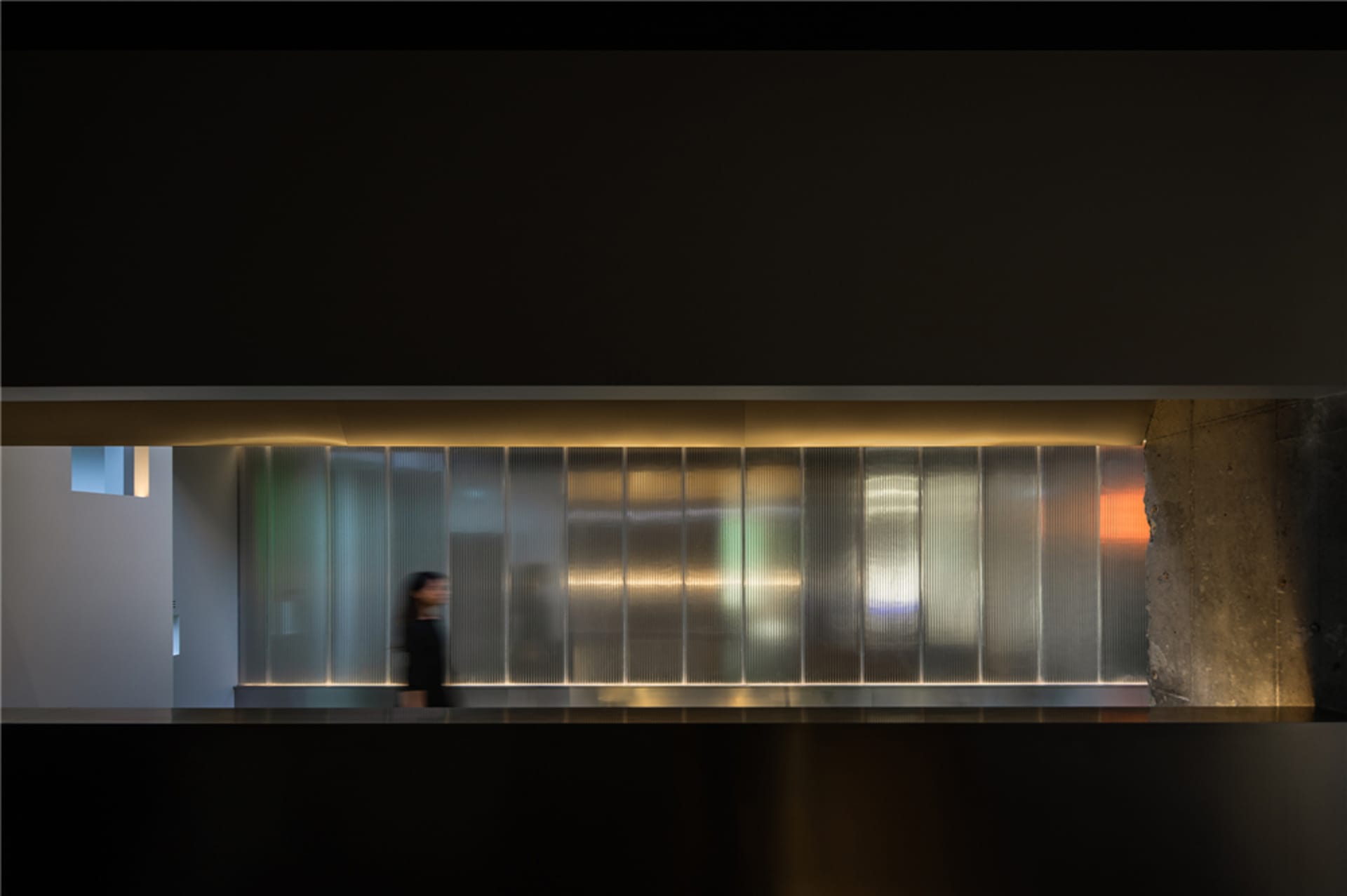 A modern interior space featuring a glass partition screen.