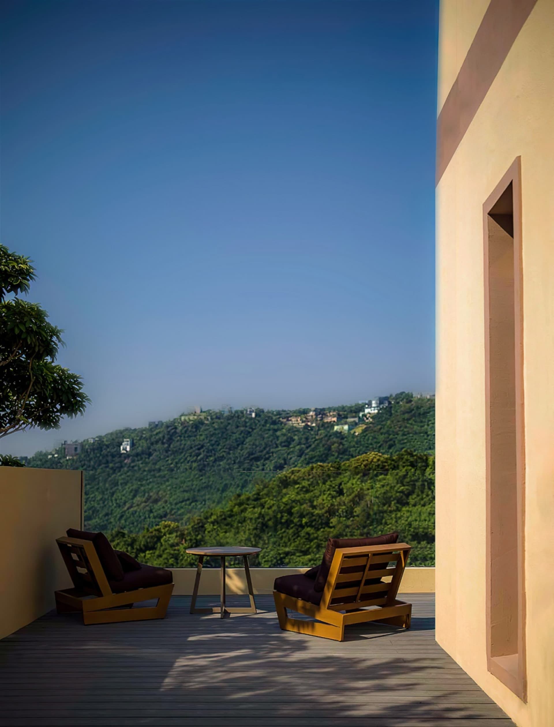 Outdoor seating area featuring comfortable cushions and a scenic mountain view.