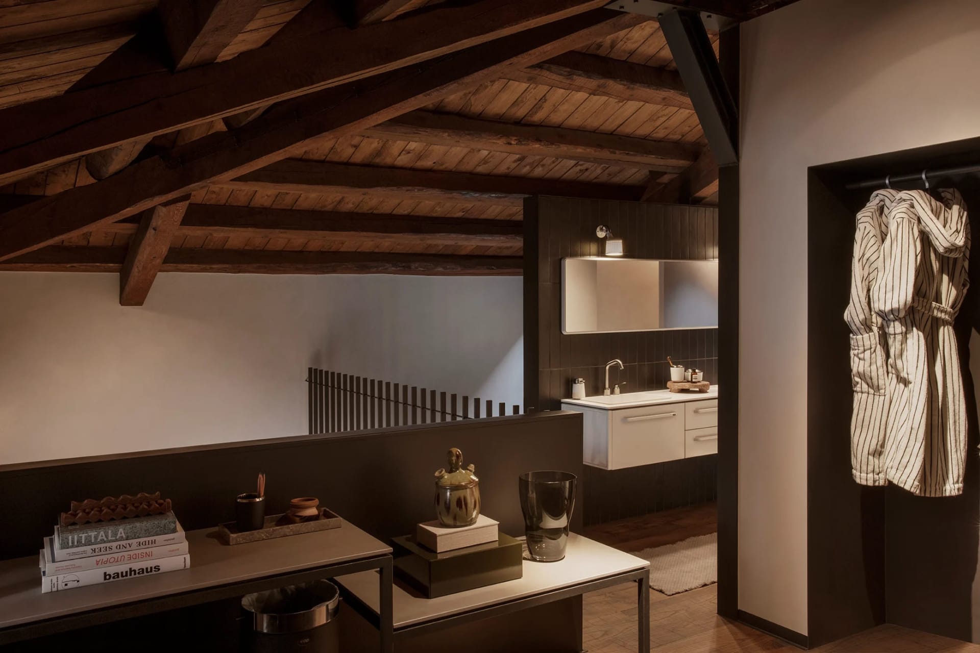 A modern bathroom with a wooden ceiling and a white sink.