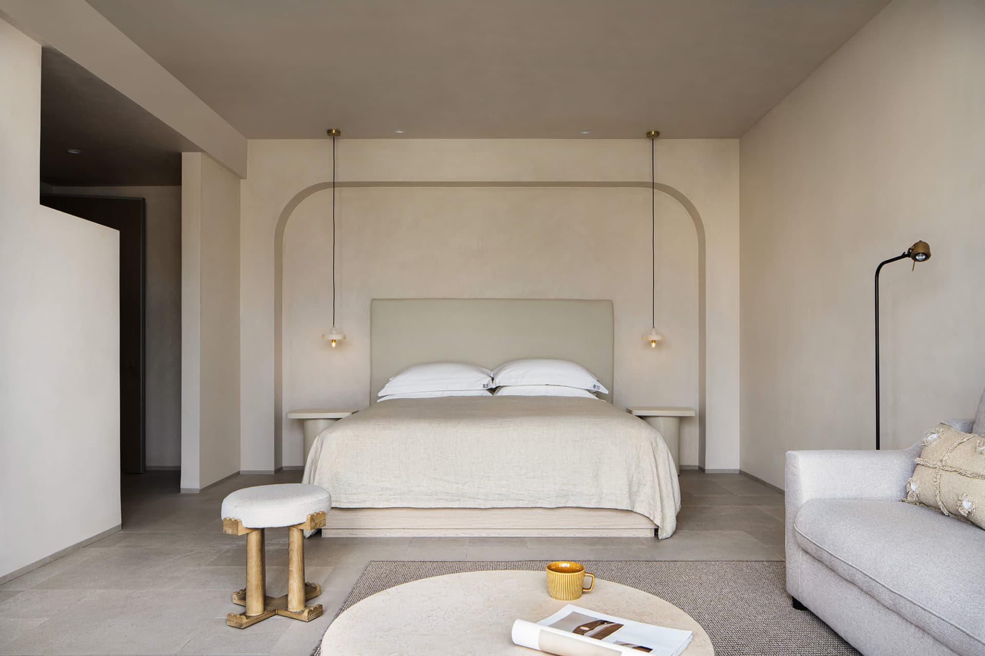 A minimalist bedroom with neutral tones and a cozy, modern feel.