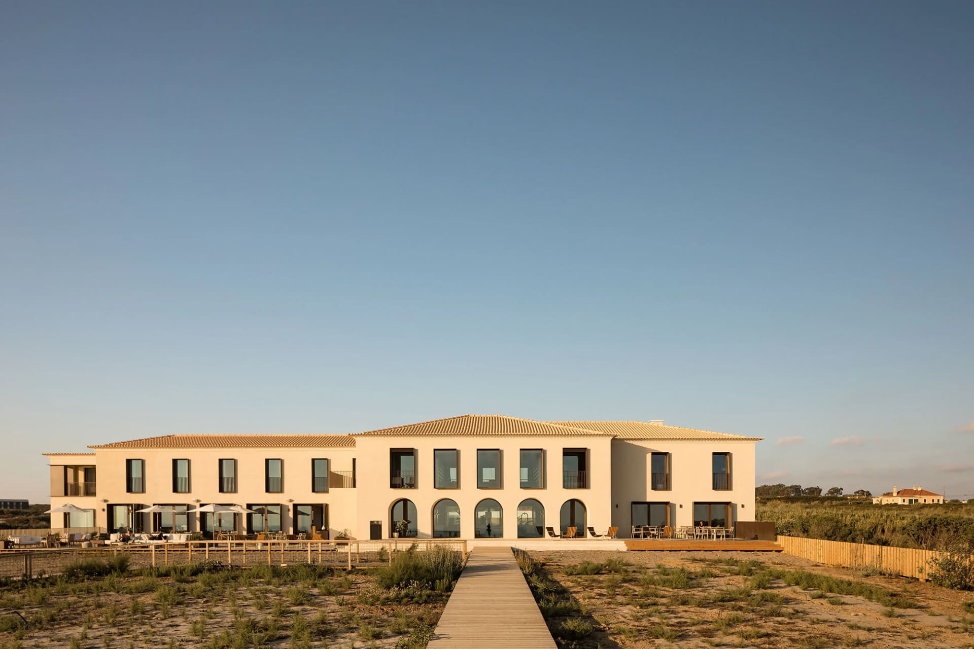 A modern style exterior of a hotel building made of sandstone material.