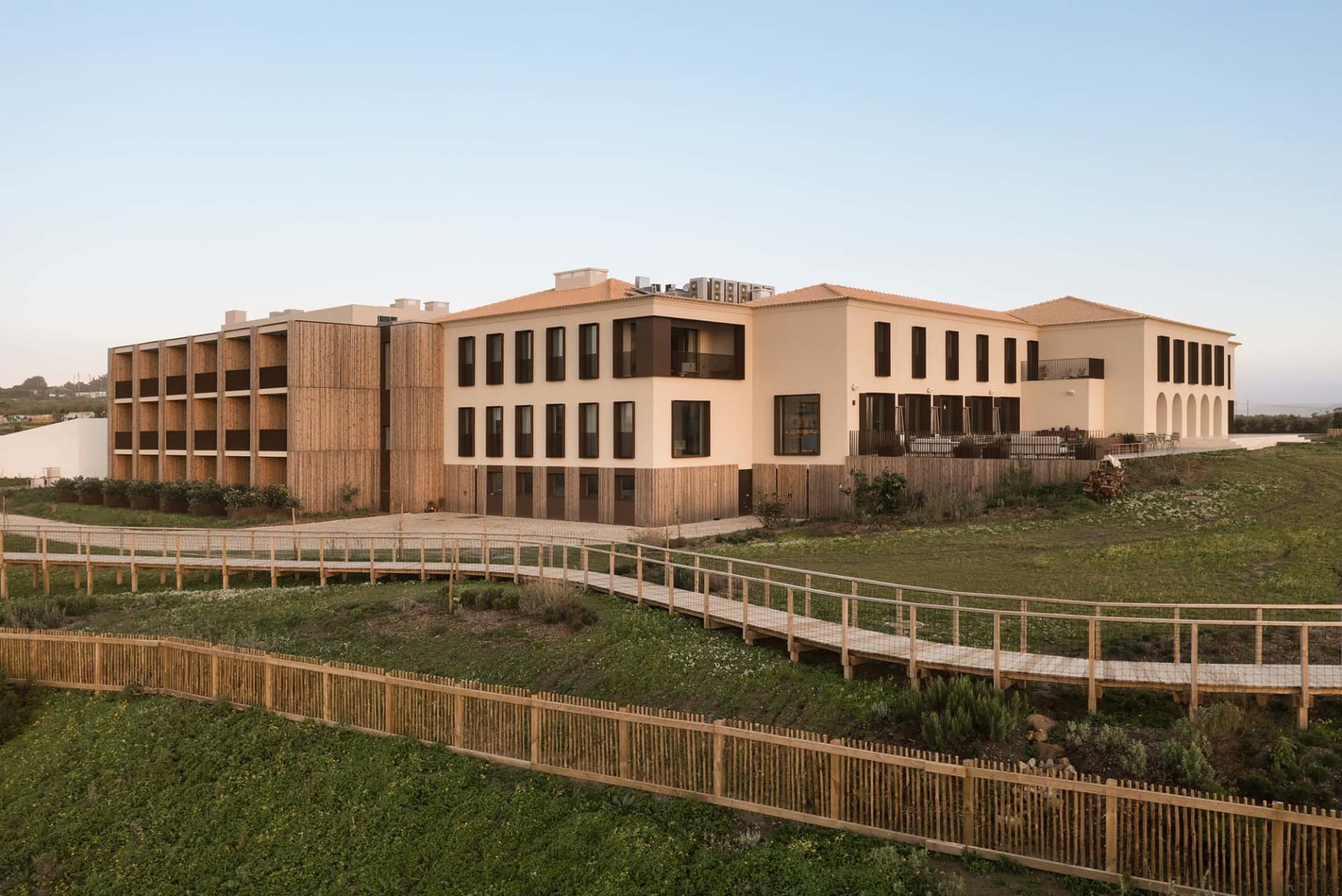 Modern commercial building with wooden frame and greenery