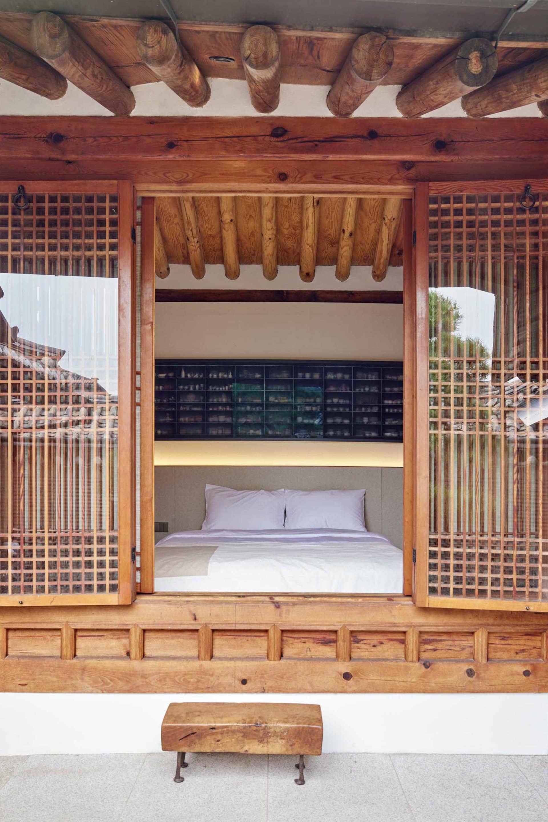 A traditional Korean bedroom featuring wooden and glass elements