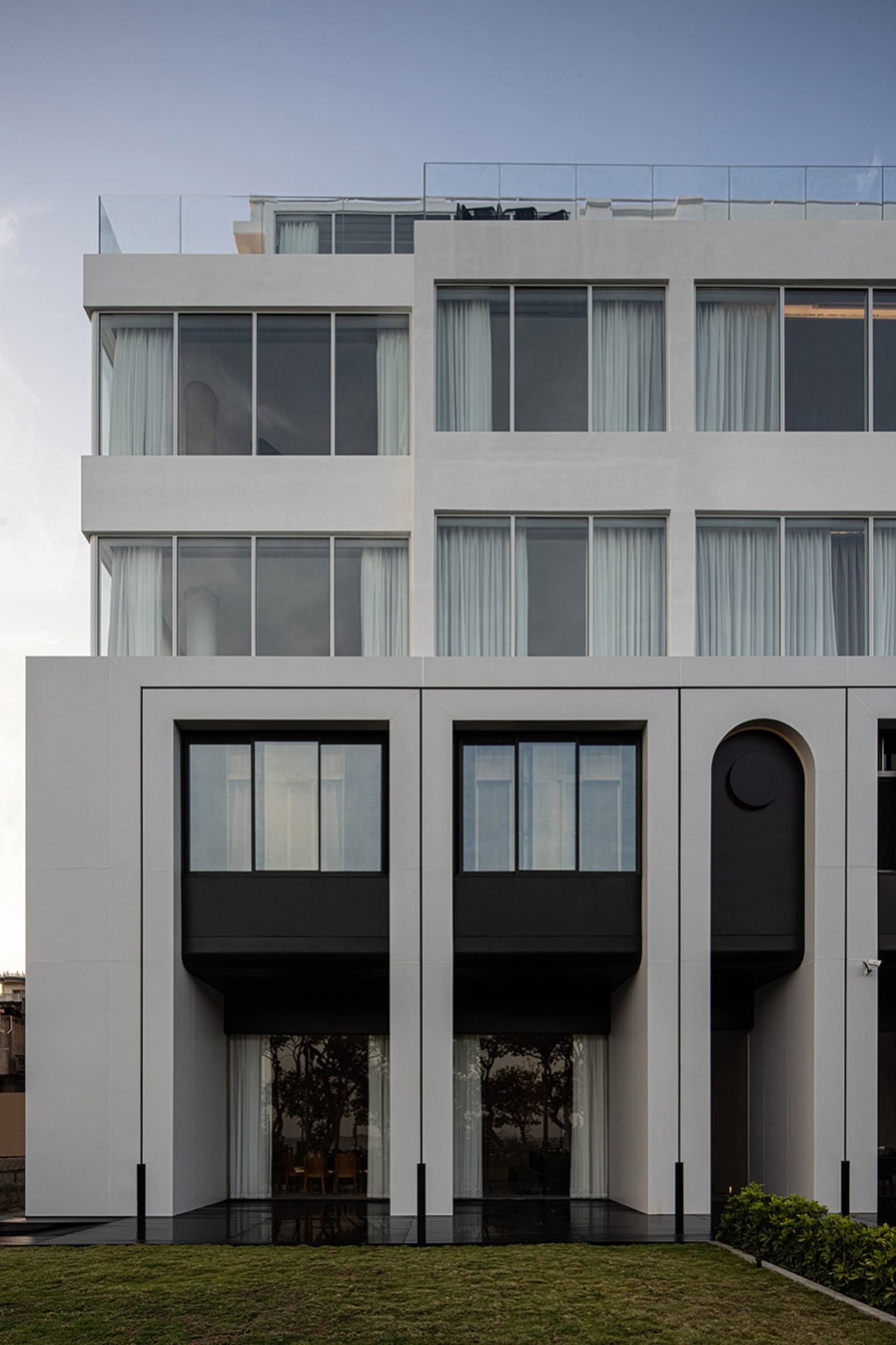 Modern building with concrete facade and large windows.