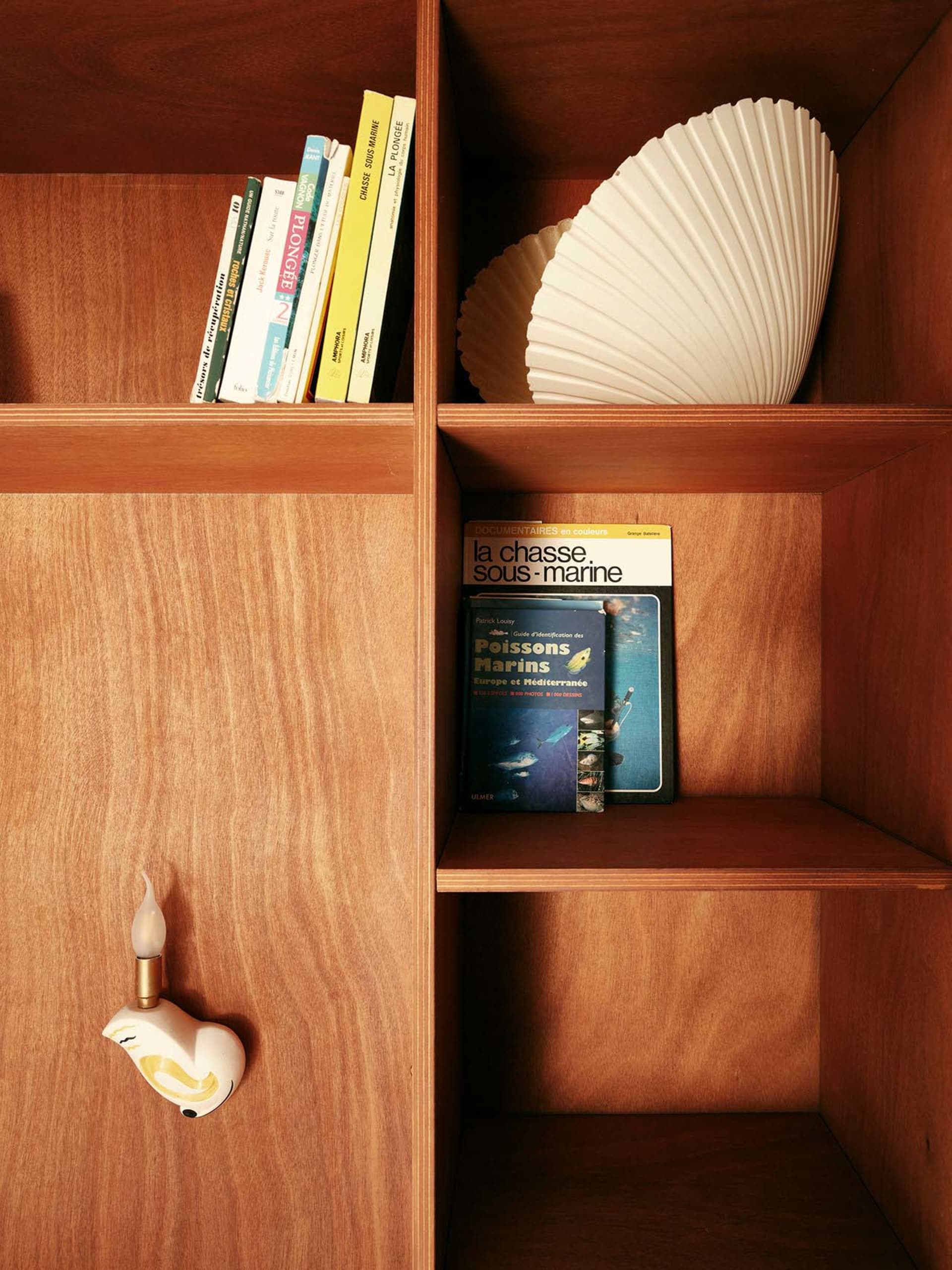 A modern wooden bookshelf with books and decorative items