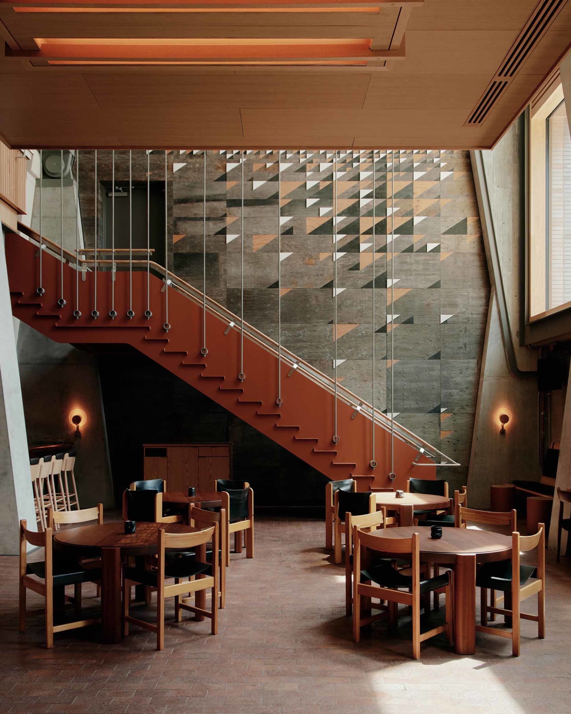 Modern, industrial restaurant interior with metal, concrete, and wooden textures.