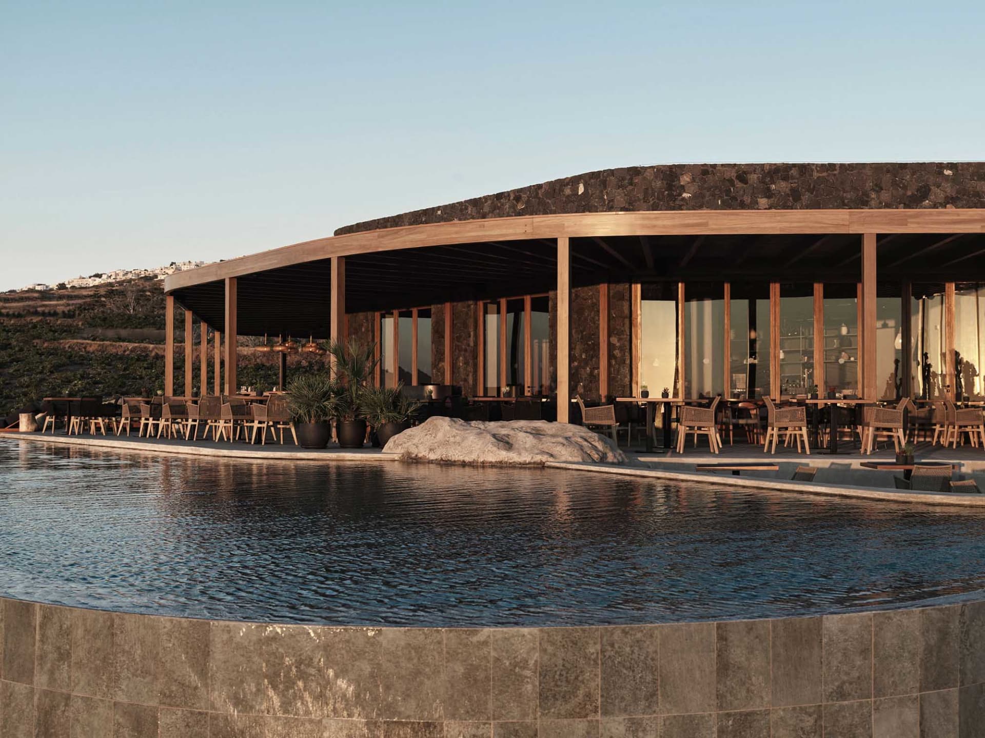 Modern restaurant exterior featuring timber and stone materials.