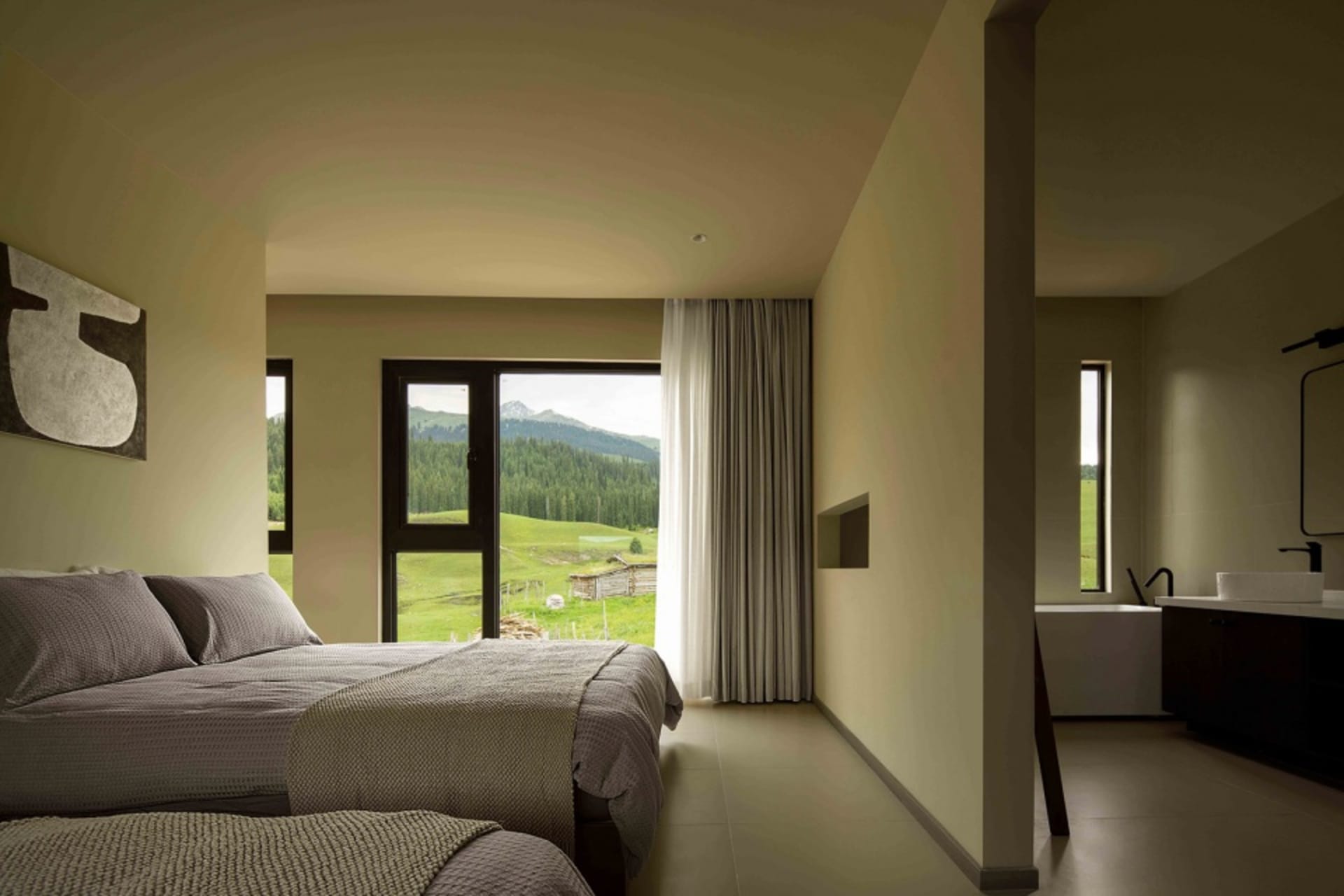 A modern minimalist bedroom featuring neutral-toned decor, a cozy bed, and a floor-to-ceiling window overlooking a green land