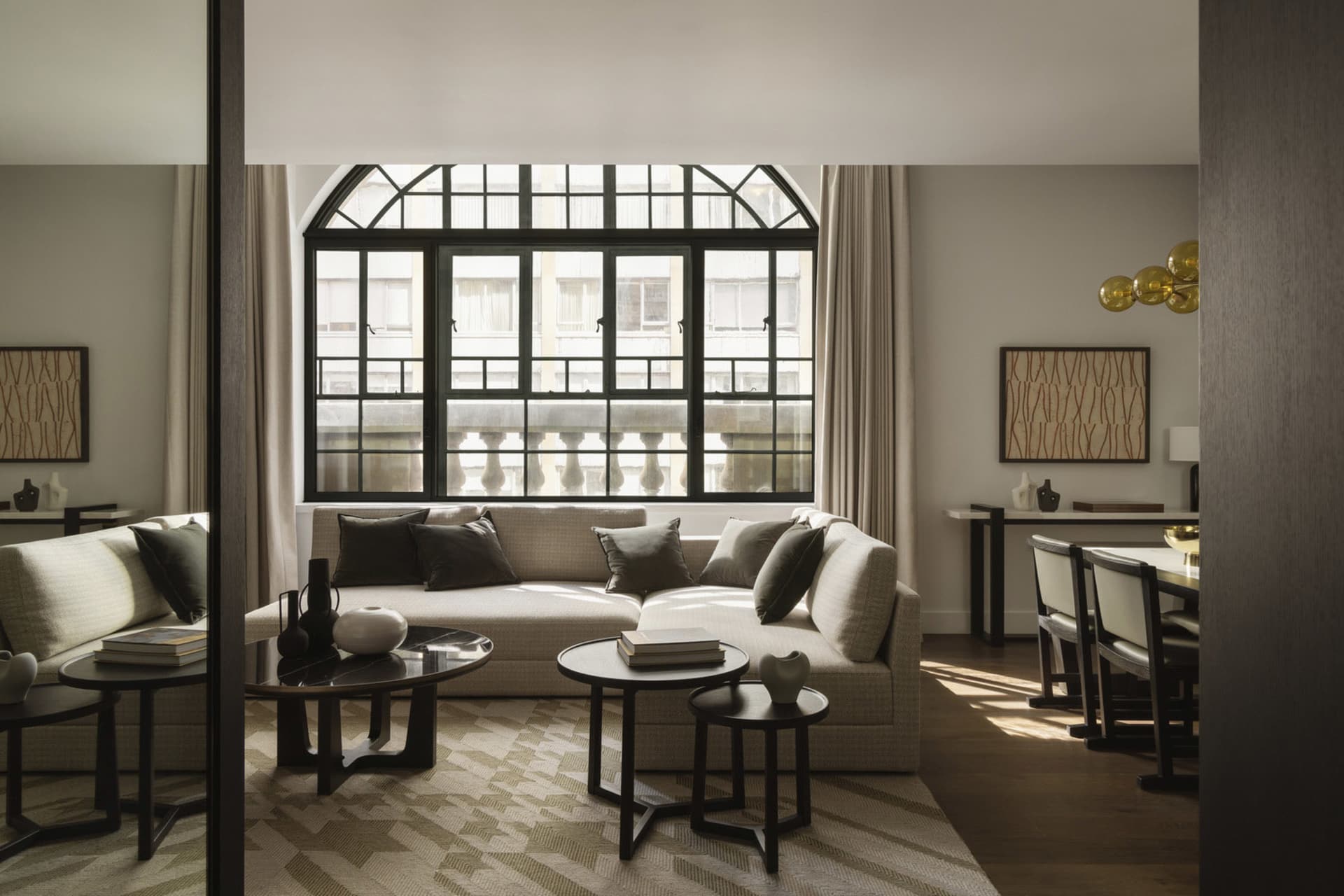 A minimalist living room with a modern couch, round side tables, and minimalistic decor.