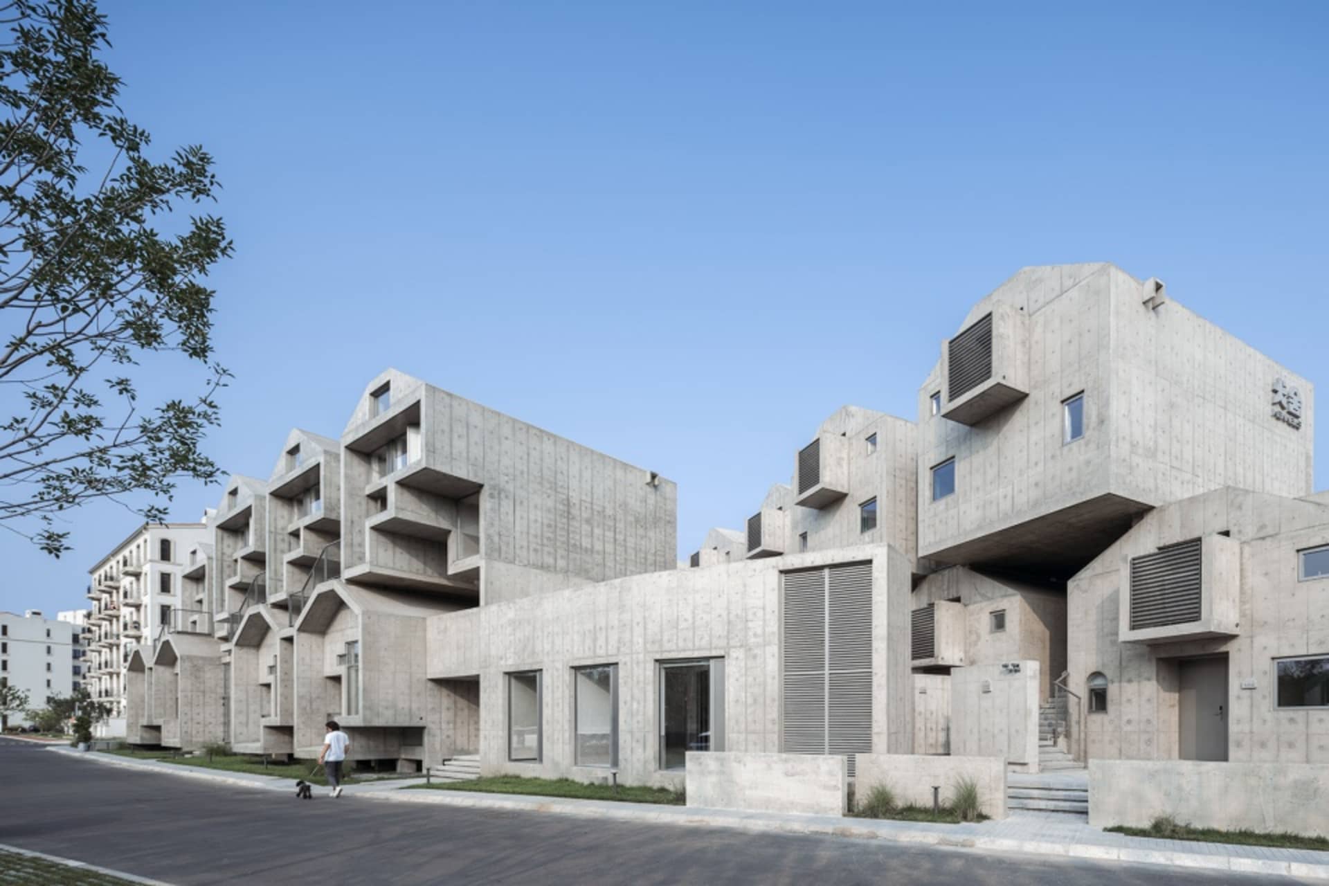 Modern residential buildings with concrete exterior and large windows.