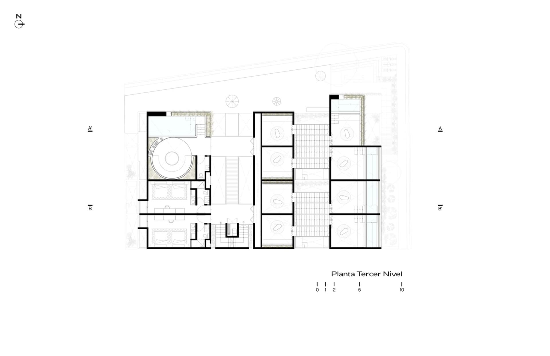 A modern architectural floor plan of a building featuring a ground-level plan with concrete flooring and multiple functional