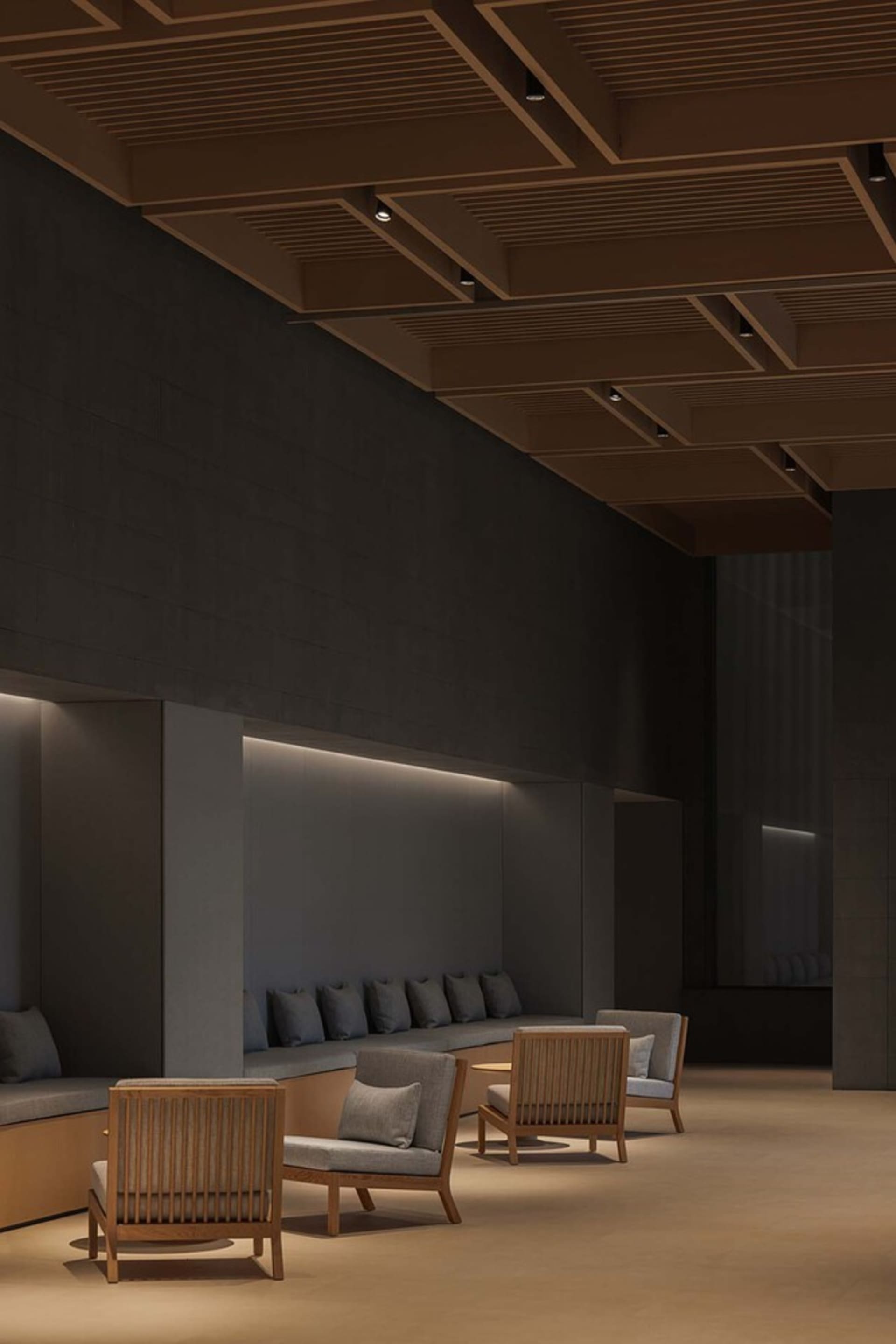 A modern lobby interior with concrete walls and floors.