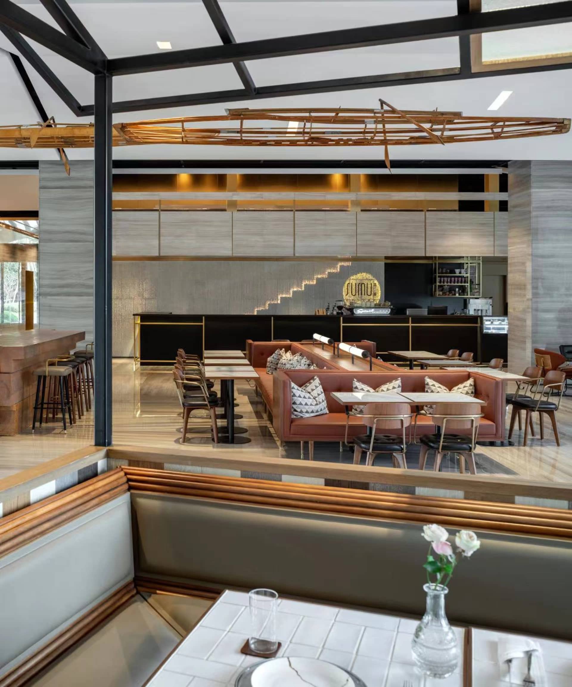 Modern restaurant interior with wood, metal, and leather furniture and decor