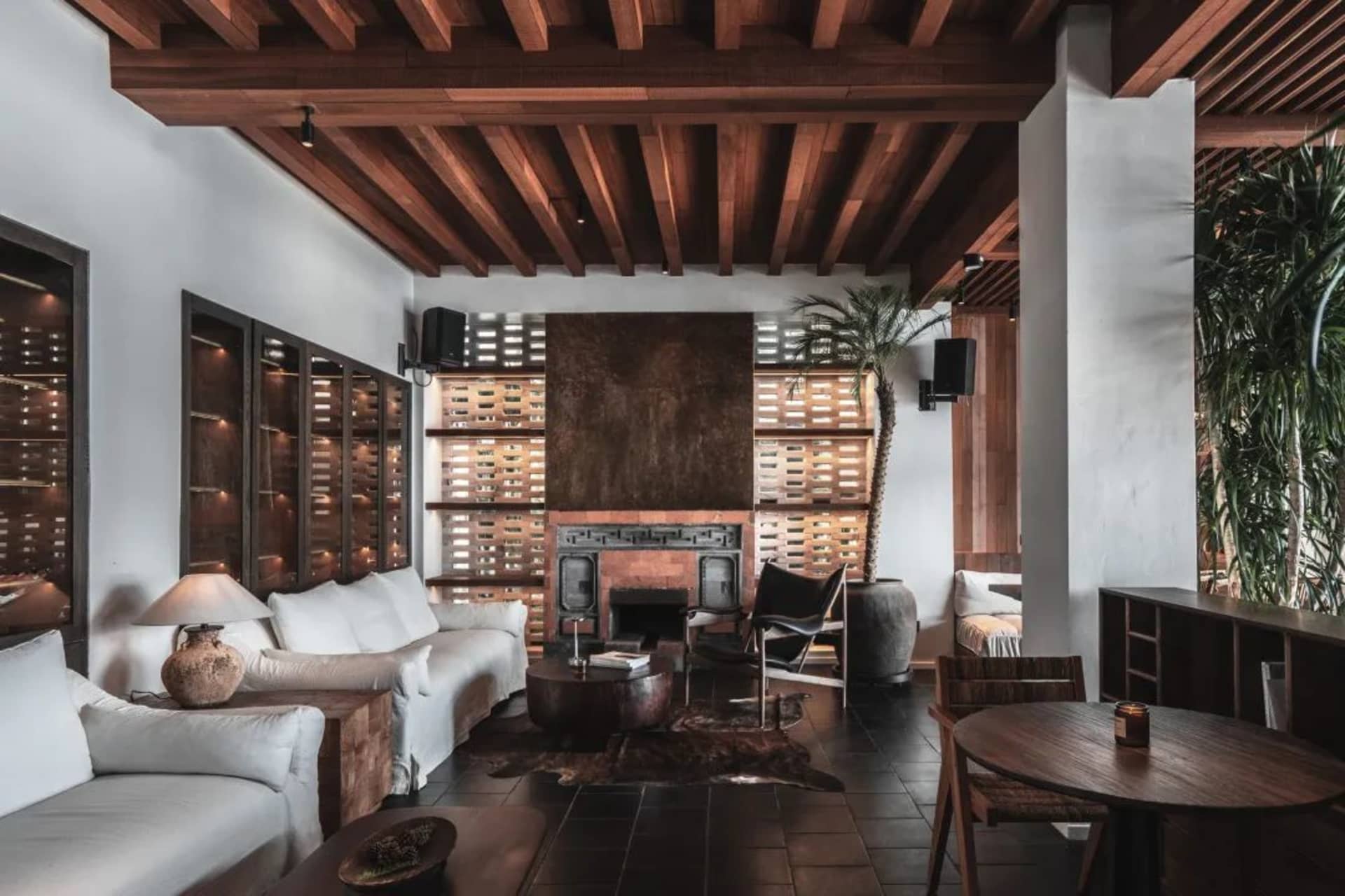 Industrial living room with wooden furniture and exposed beams.