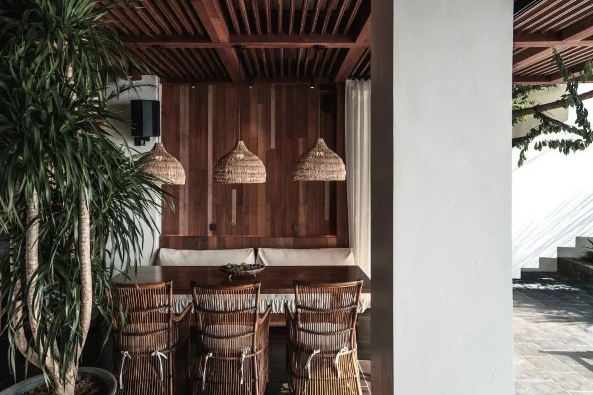Industrial-style restaurant with wooden furniture and pendant lights.