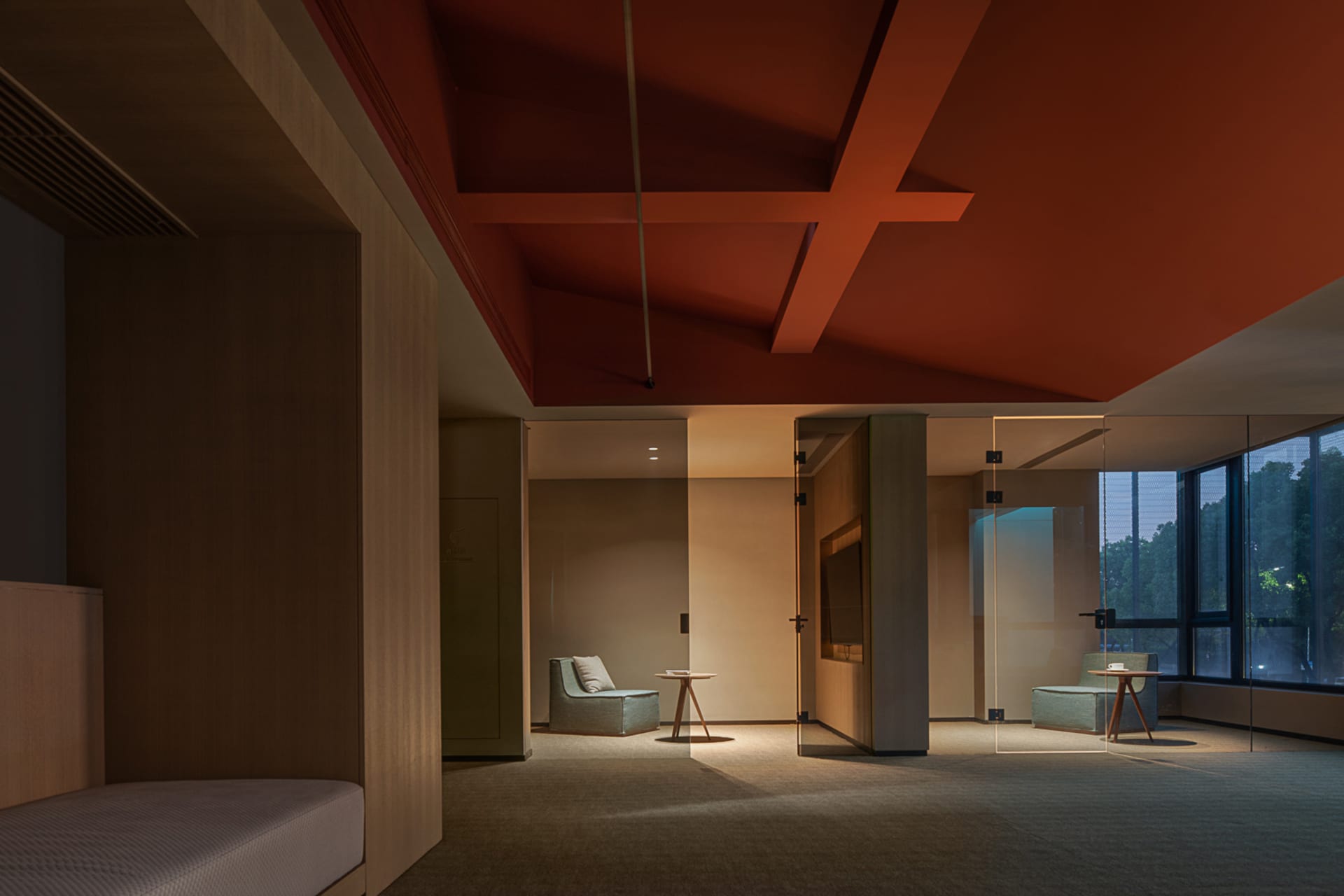 Modern hotel suite with glass walls and wooden furniture