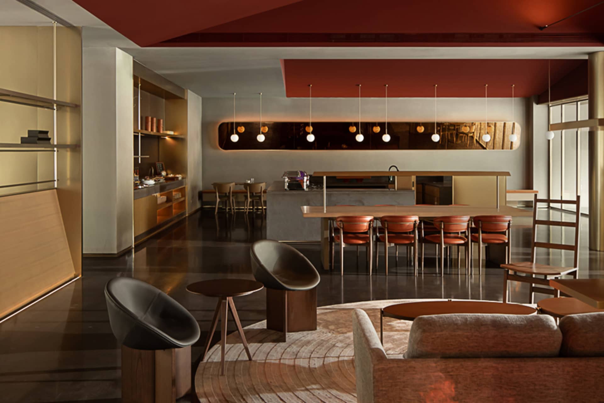 A modern residential living area featuring concrete walls and wooden furniture.