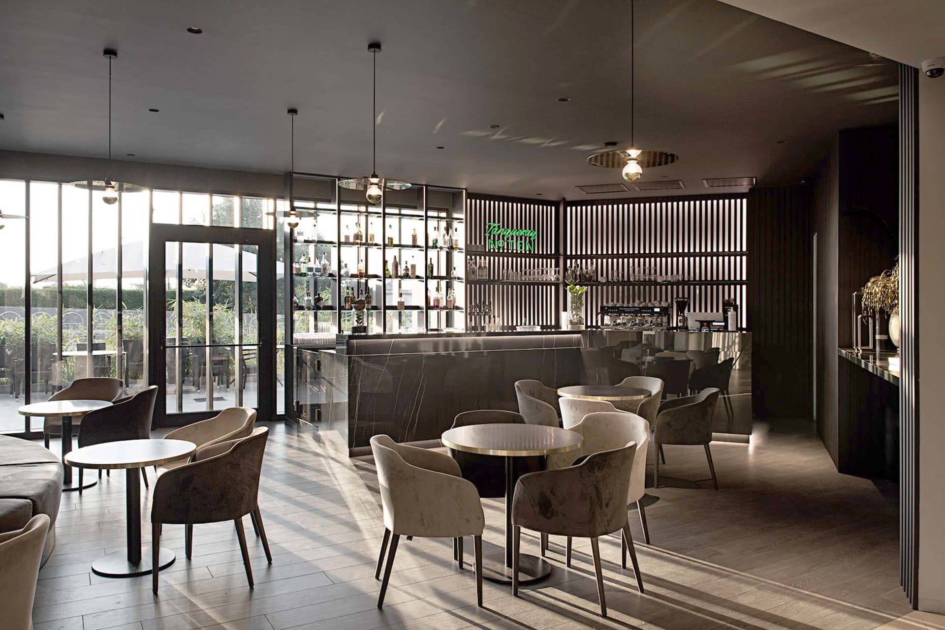Modern restaurant bar area with concrete flooring and minimalist decor.