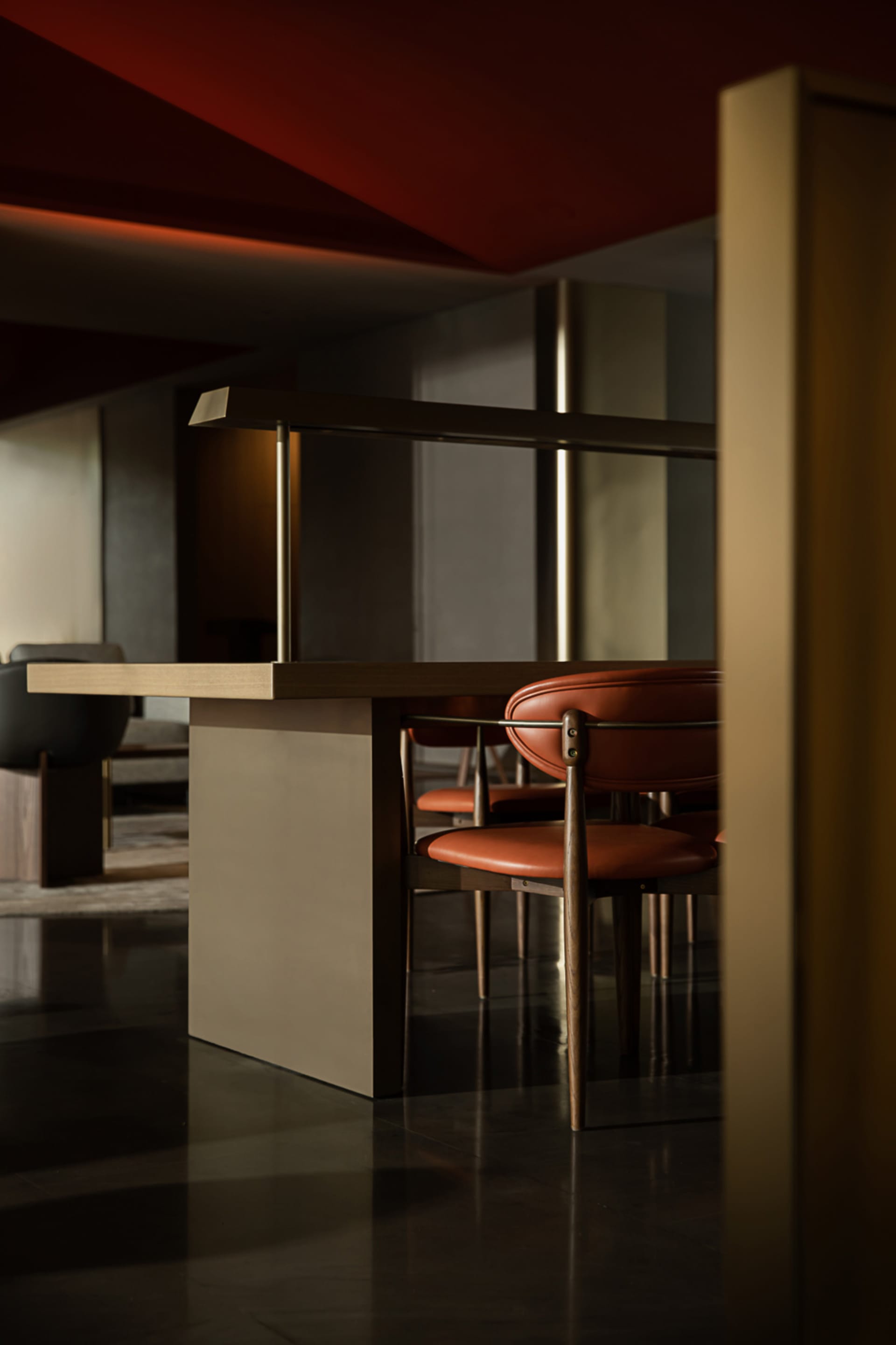 Modern restaurant seating area with wooden furniture and leather upholstery.