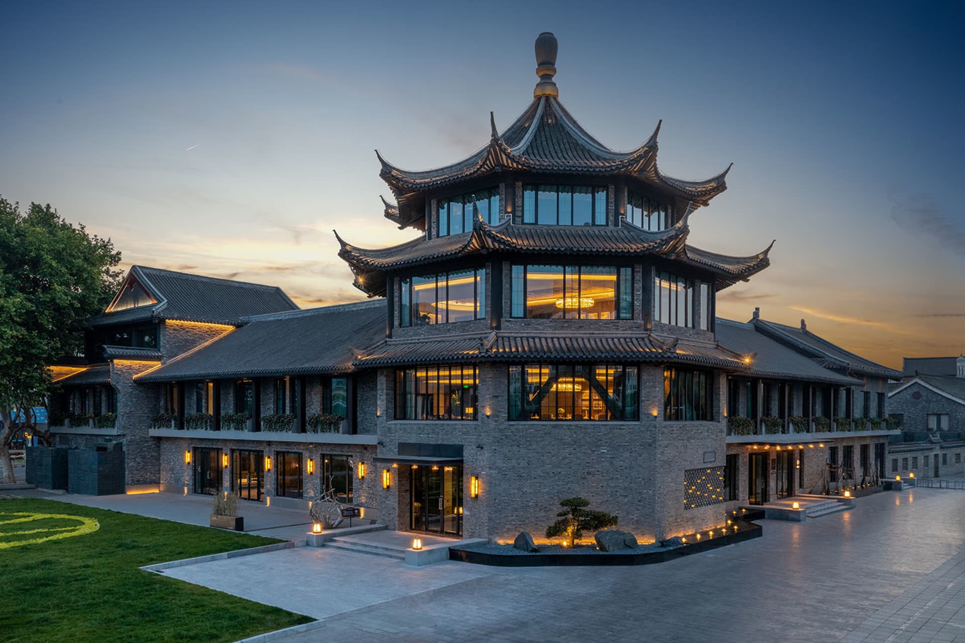 A modern building with a brick exterior and traditional Chinese architectural design.