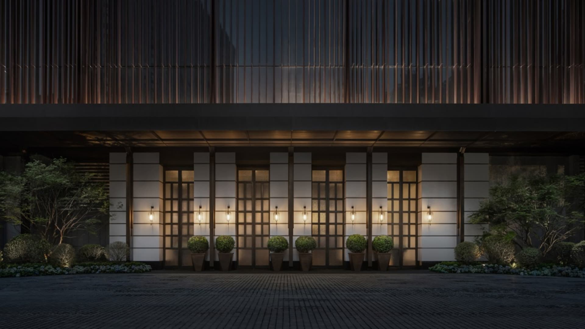A modern office entrance featuring glass and concrete materials, with a welcoming atmosphere.