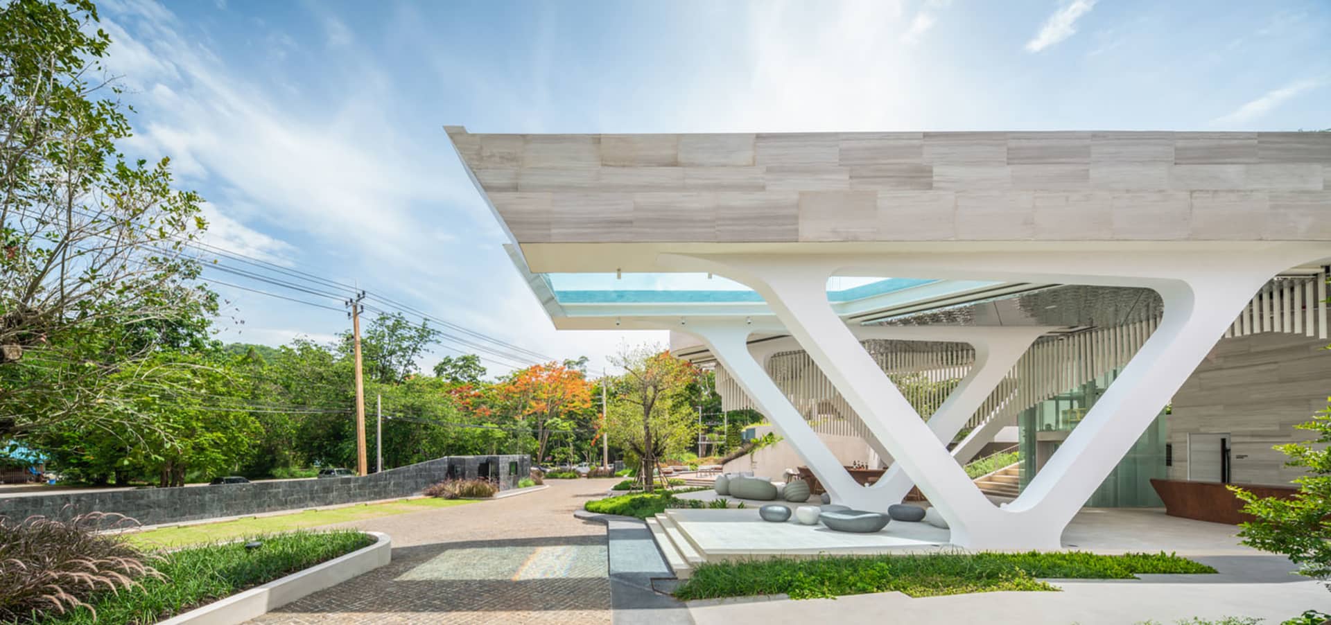 A modern building with a white marble exterior and a large sculptural entrance.