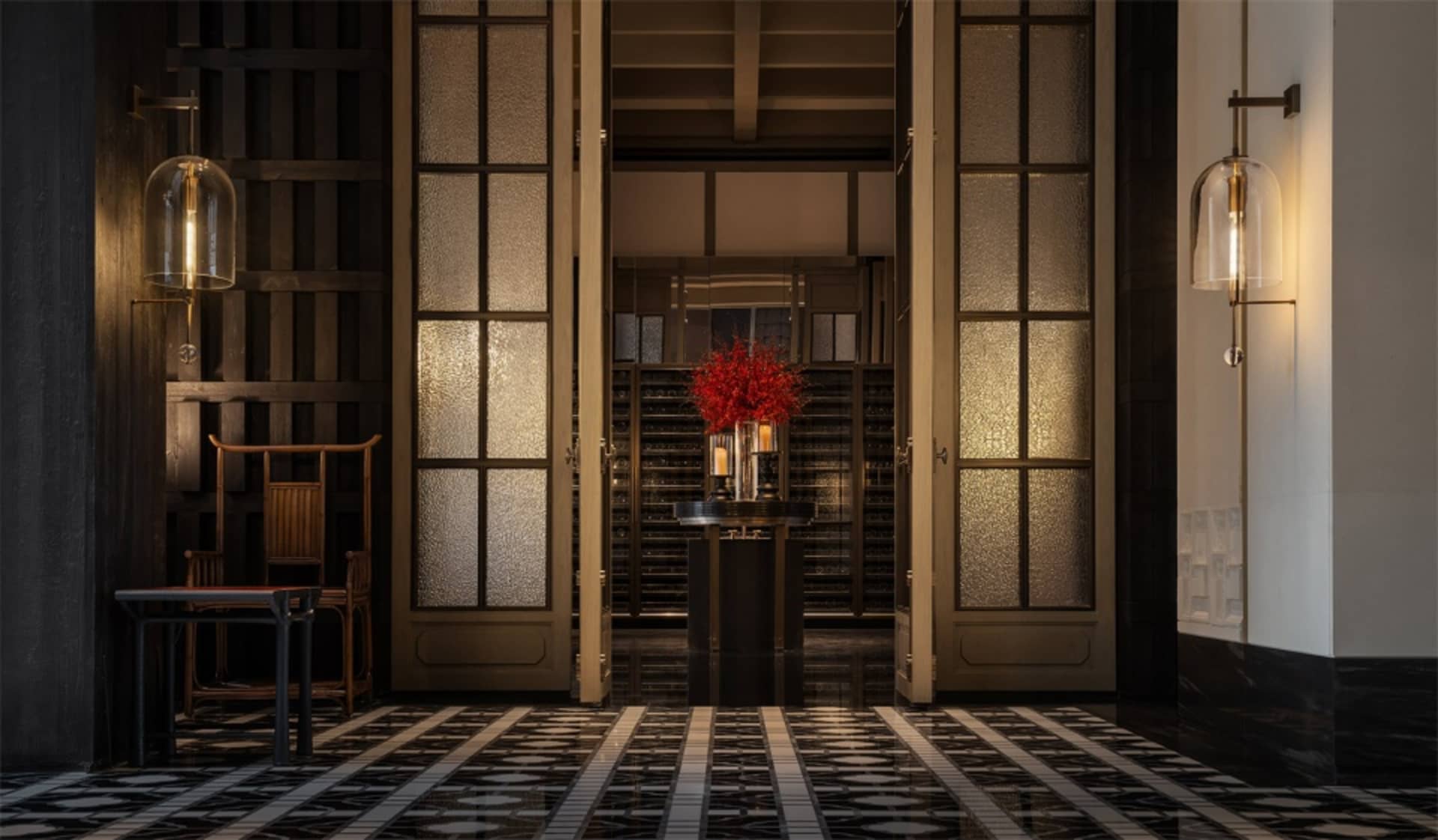 A minimalist modern lobby with glass, metal, and stone materials.