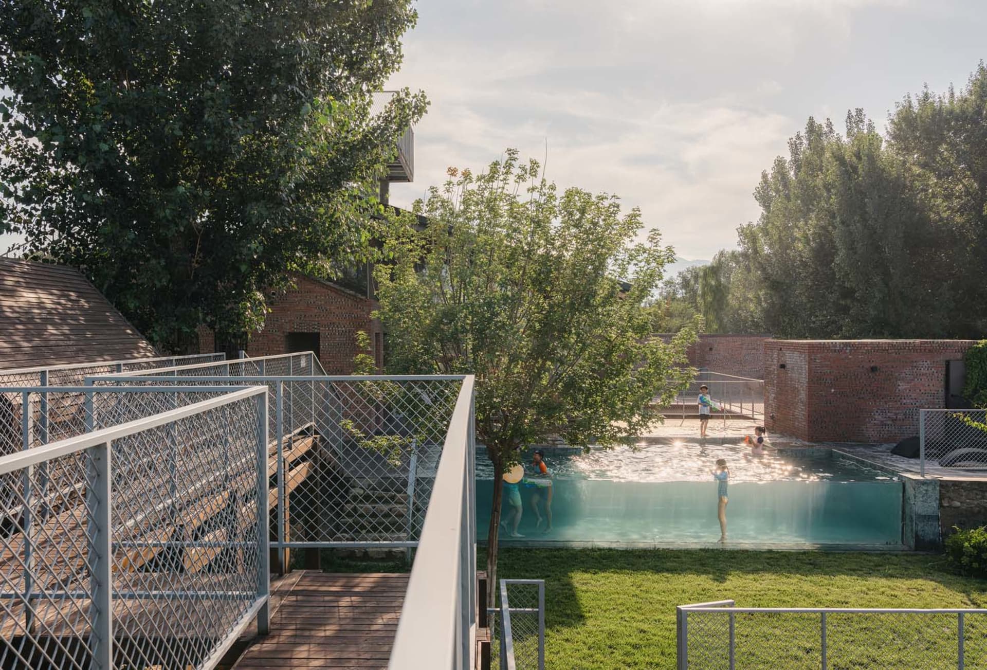 Poolside area with concrete, brick, and metal structures