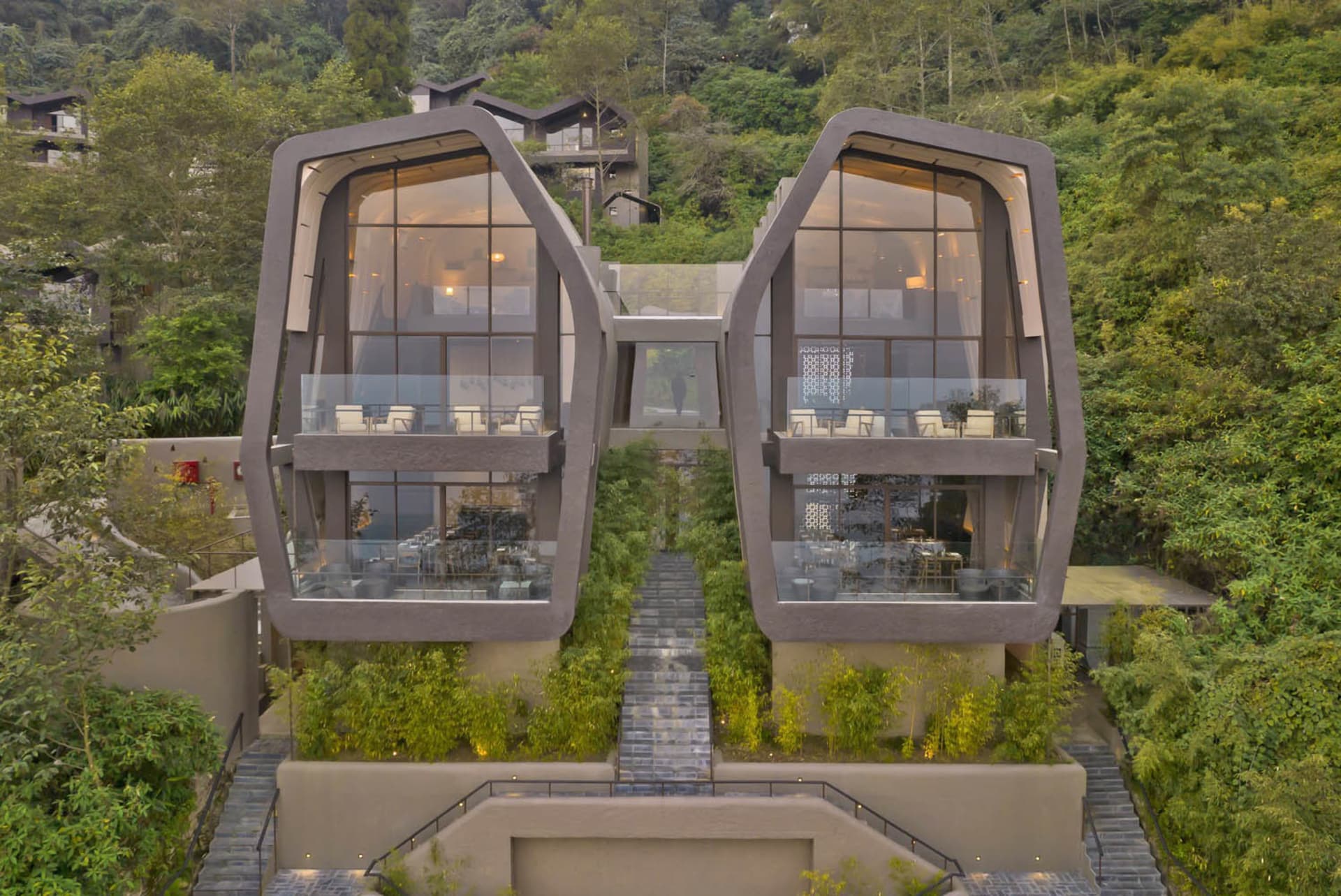 Modern residential house with concrete facade and large glass windows