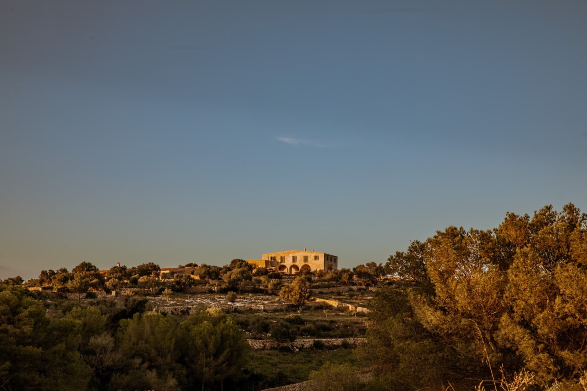 Residential buildings nestled on a stone hillside.