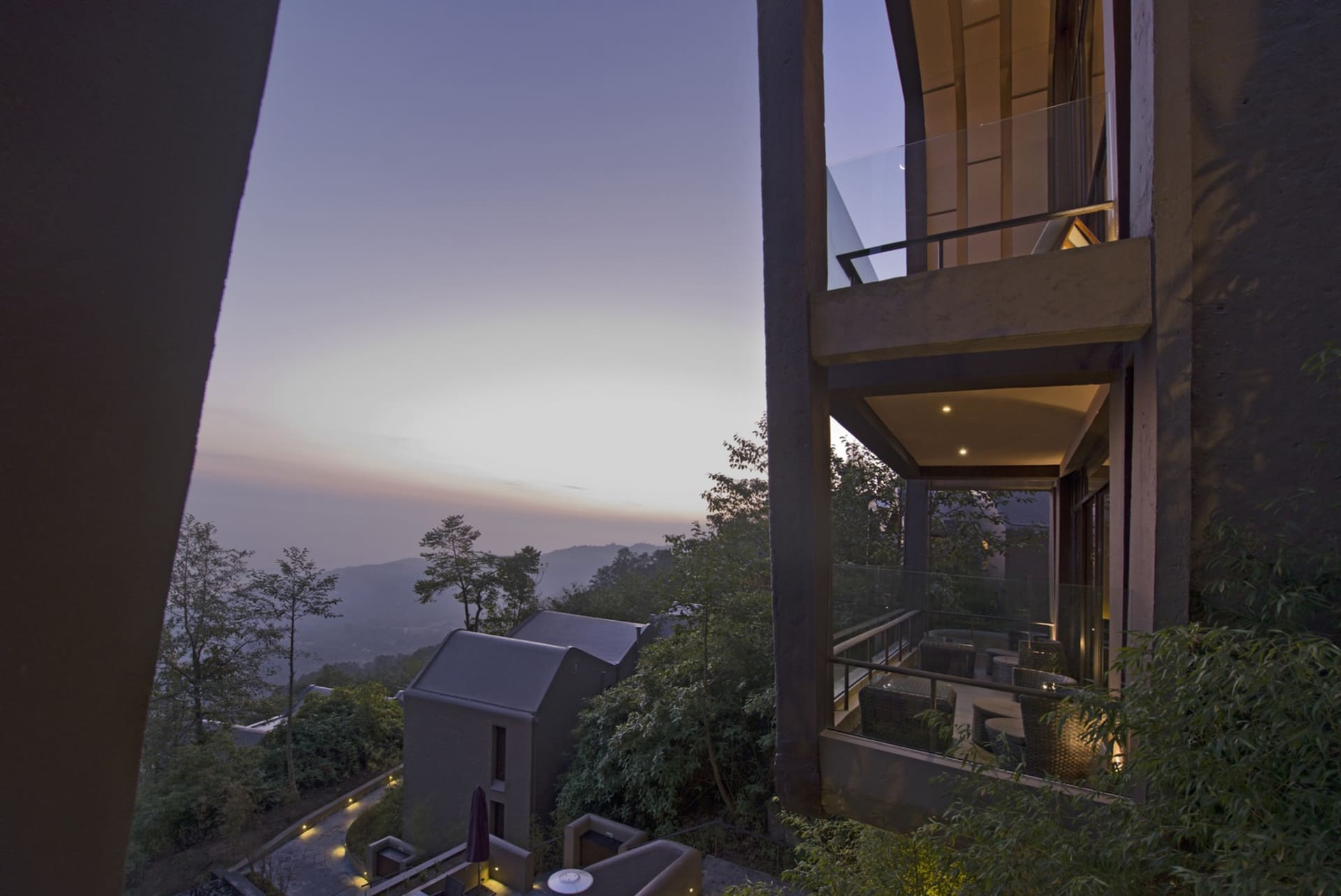 Modern residential veranda featuring wood, glass, and metal elements.