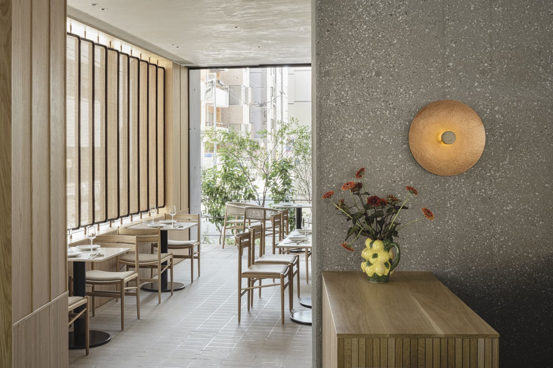 Modern restaurant interior showcasing contemporary design with wooden materials and sleek, minimalist decor.