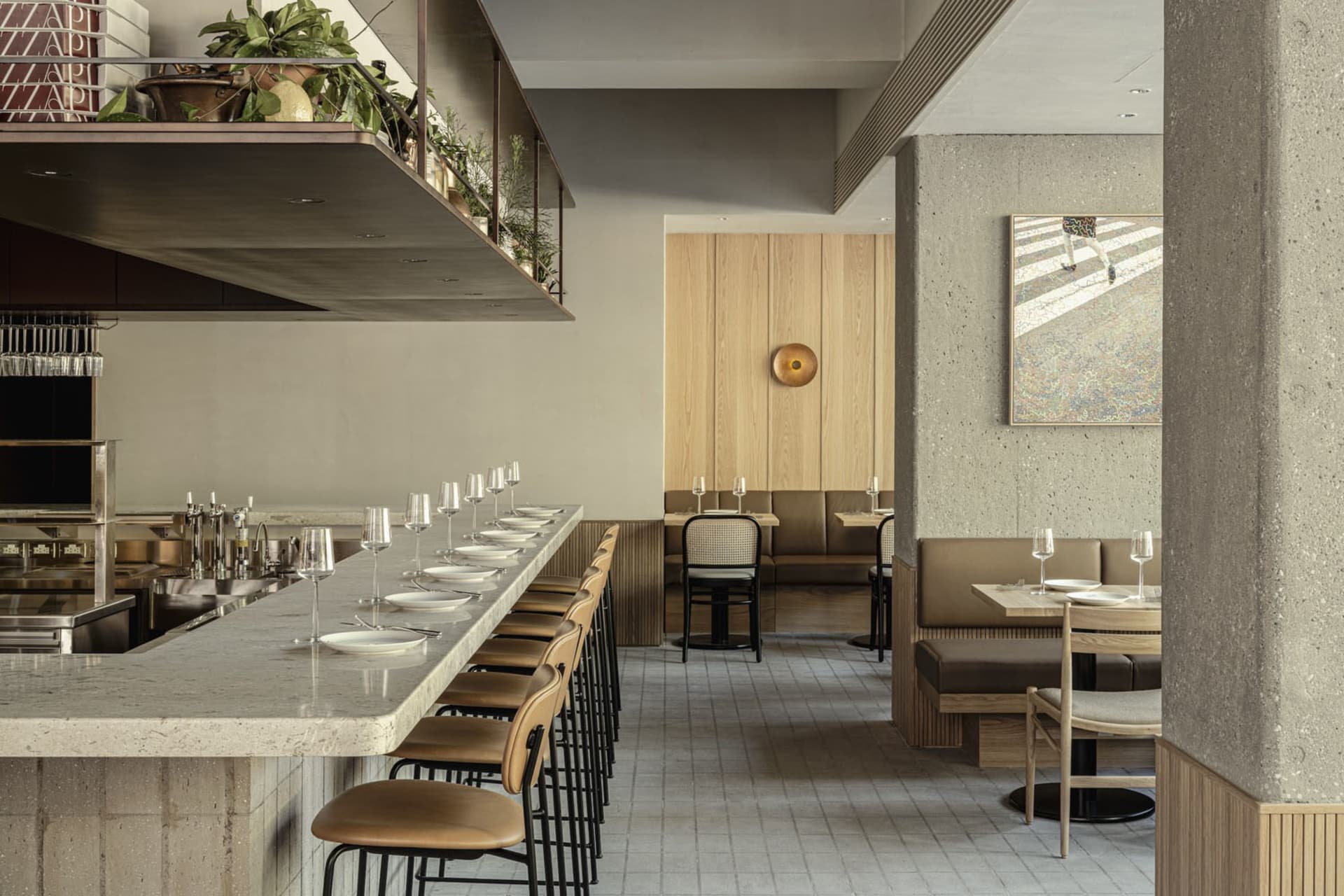A modern restaurant interior with concrete walls and wooden seating