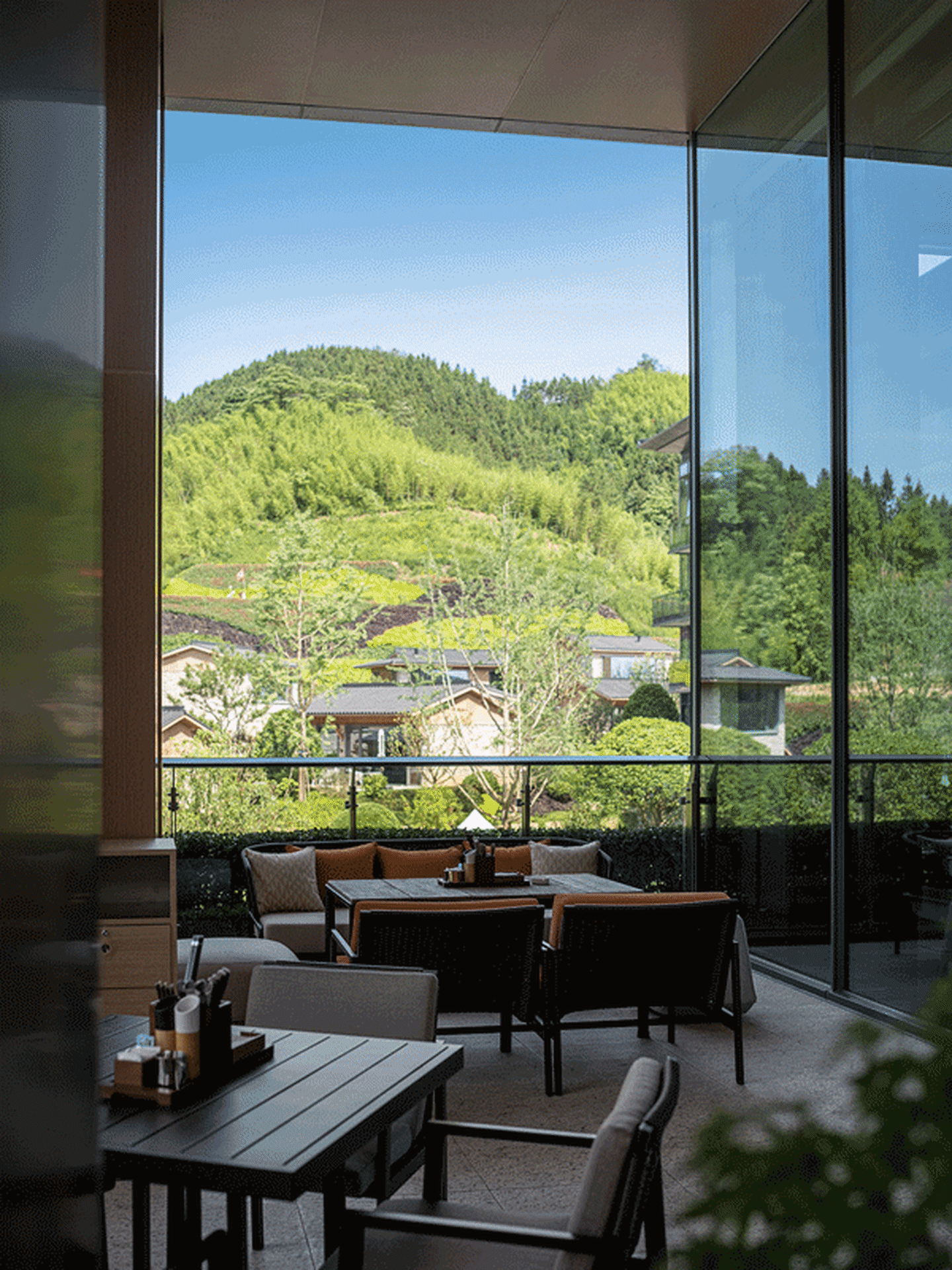Outdoor seating area with wooden furniture and mountain view