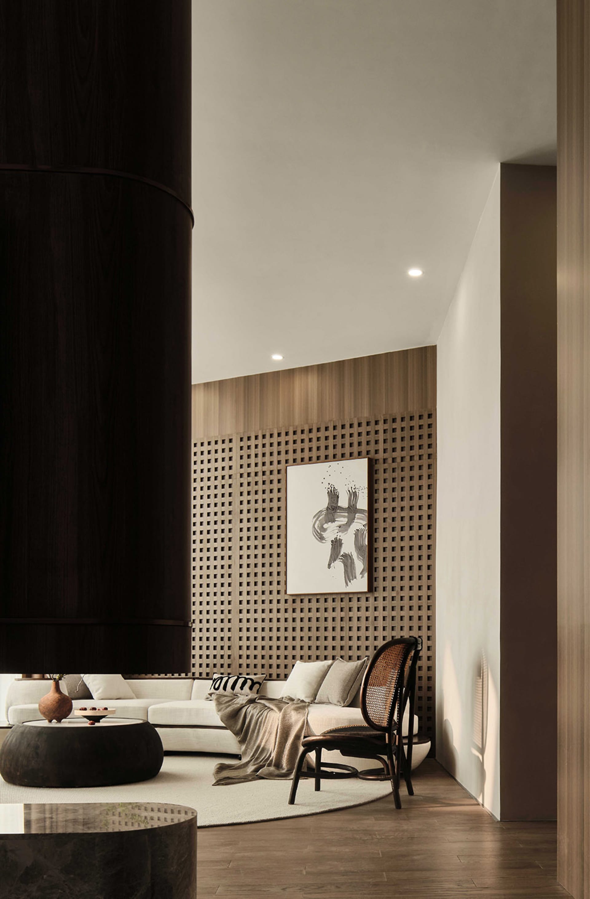 A modern living room featuring a wooden sofa, chair, and coffee table under natural light.