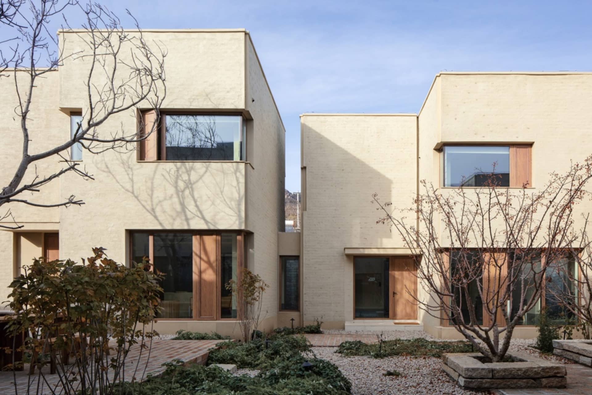 Modern residential architecture featuring concrete and wood exteriors.