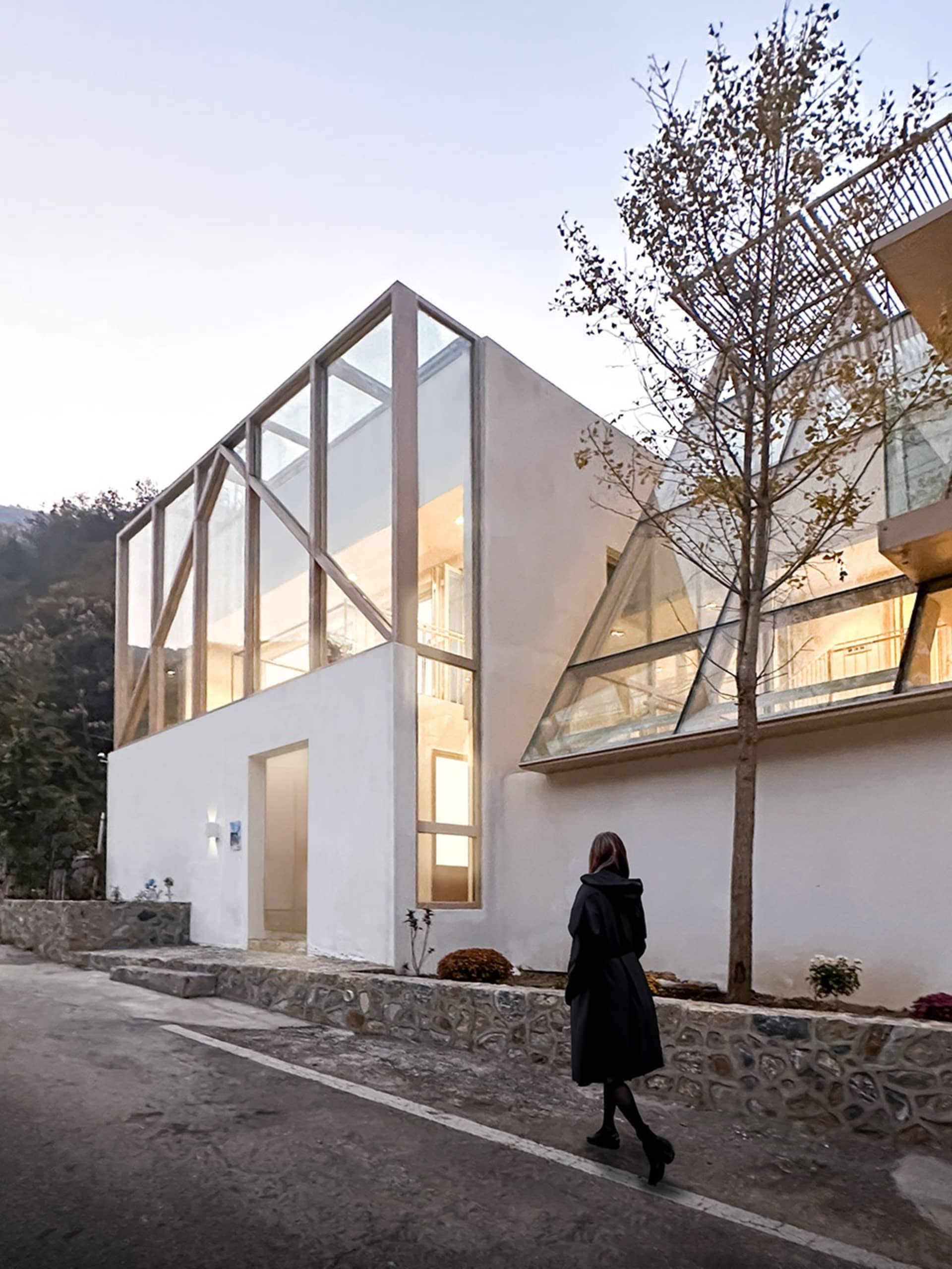 Modern building with large glass windows and white walls.