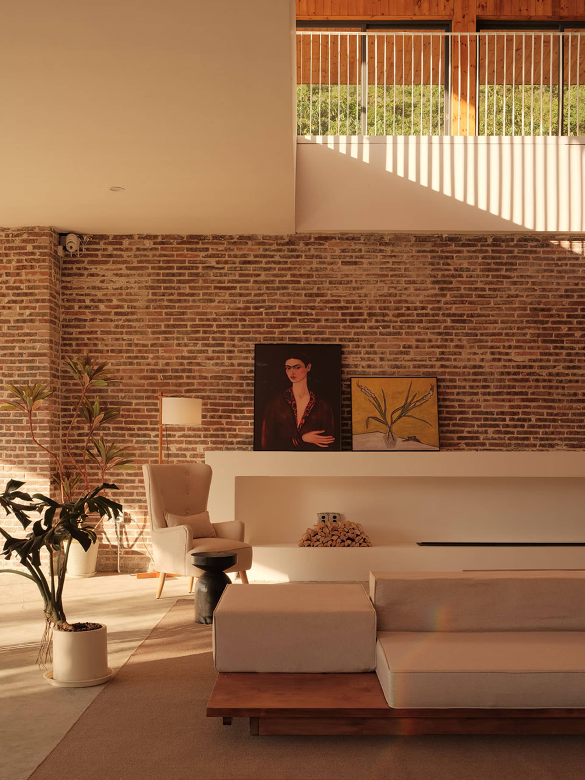 Industrial living room featuring a brick wall and concrete floor.