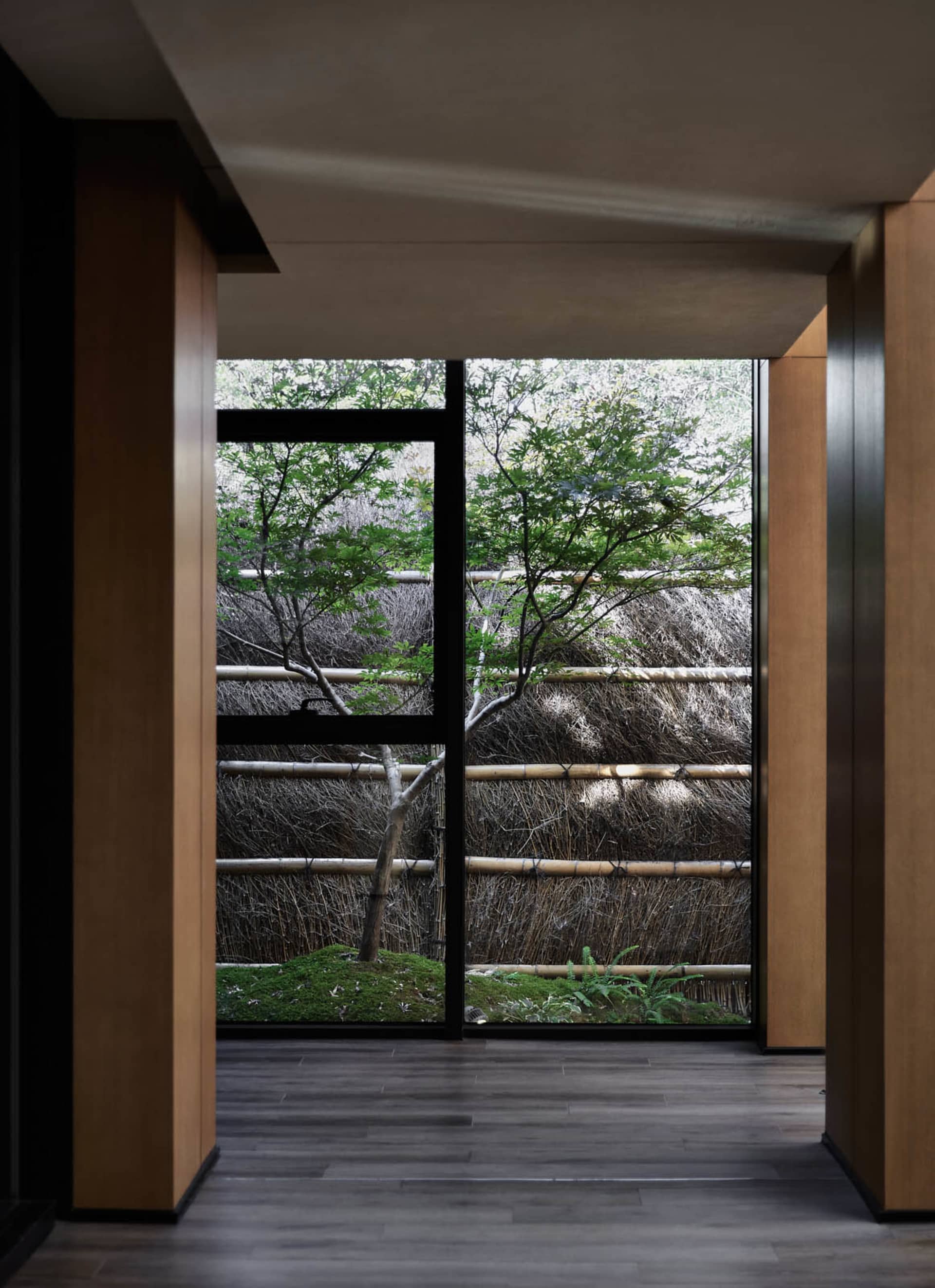 A view through a wooden window in an industrial-style room.