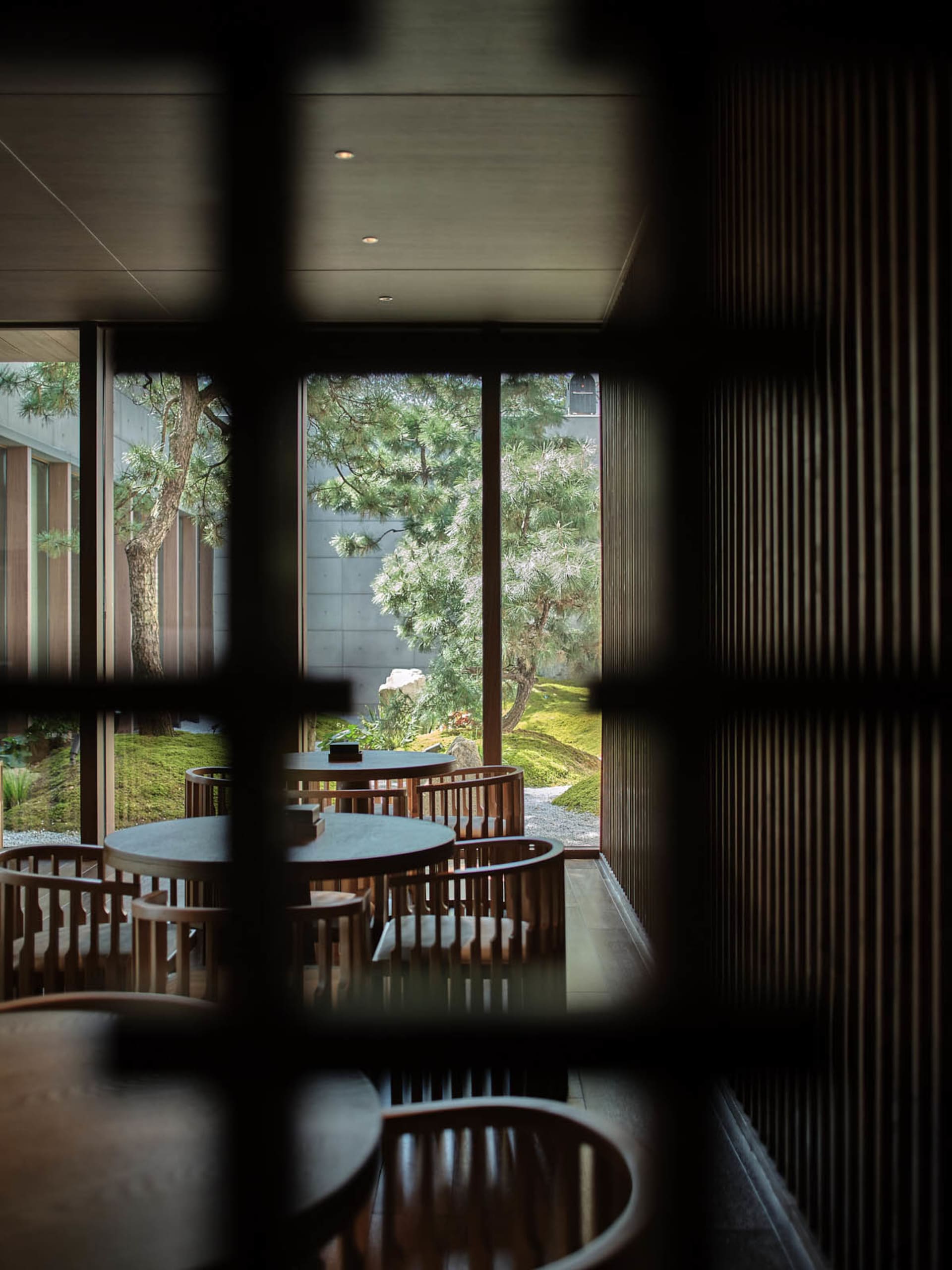 A modern restaurant cafe interior featuring wooden tables and chairs.