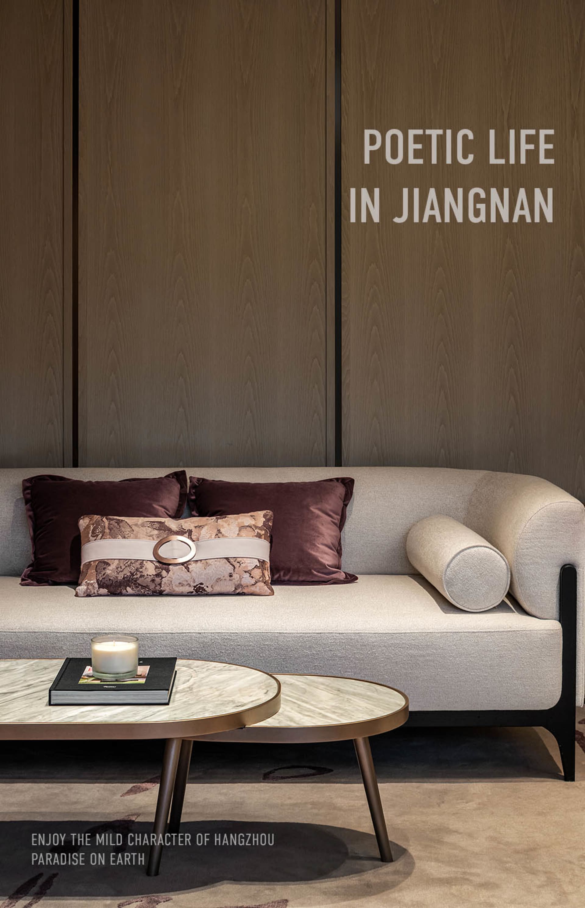 A modern living room with a fabric couch, wooden paneling, and marble accents.